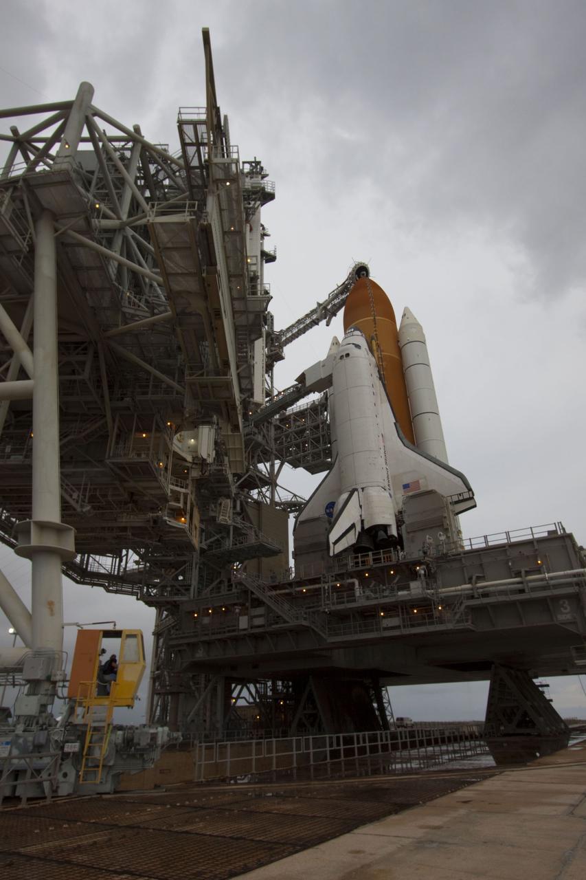 CAPE CANAVERAL, Fla. -- A worker in a control booth on Launch Pad 39A at NASA's Kennedy Space Center in Florida monitors the progress of the rotating service structure (RSS) as it is rolled back revealing space shuttle Atlantis. The structure provides weather protection and access to the shuttle while it awaits liftoff on the pad. RSS "rollback" marks a major milestone in Atlantis' STS-135 mission countdown.        Atlantis and its crew of four; Commander Chris Ferguson, Pilot Doug Hurley and Mission Specialists Sandy Magnus and Rex Walheim, are scheduled to lift off at 11:26 a.m. EDT on July 8 to deliver the Raffaello multi-purpose logistics module packed with supplies and spare parts to the International Space Station. Atlantis also will fly the Robotic Refueling Mission experiment that will investigate the potential for robotically refueling existing satellites in orbit. In addition, Atlantis will return with a failed ammonia pump module to help NASA better understand the failure mechanism and improve pump designs for future systems. STS-135 will be the 33rd flight of Atlantis, the 37th shuttle mission to the space station, and the 135th and final mission of NASA's Space Shuttle Program. For more information visit, www.nasa.gov/mission_pages/shuttle/shuttlemissions/sts135/index.html. Photo credit: NASA/Troy Cryder