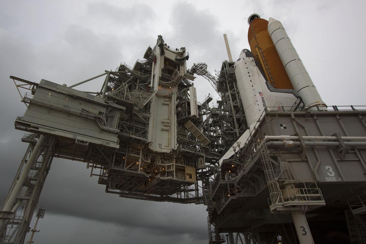 CAPE CANAVERAL, Fla. -- Space shuttle Atlantis is revealed on Launch Pad 39A at NASA's Kennedy Space Center in Florida following the move of the rotating service structure (RSS). The structure provides weather protection and access to the shuttle while it awaits liftoff on the pad. RSS "rollback" marks a major milestone in Atlantis' STS-135 mission countdown.    Atlantis and its crew of four; Commander Chris Ferguson, Pilot Doug Hurley and Mission Specialists Sandy Magnus and Rex Walheim, are scheduled to lift off at 11:26 a.m. EDT on July 8 to deliver the Raffaello multi-purpose logistics module packed with supplies and spare parts to the International Space Station. Atlantis also will fly the Robotic Refueling Mission experiment that will investigate the potential for robotically refueling existing satellites in orbit. In addition, Atlantis will return with a failed ammonia pump module to help NASA better understand the failure mechanism and improve pump designs for future systems. STS-135 will be the 33rd flight of Atlantis, the 37th shuttle mission to the space station, and the 135th and final mission of NASA's Space Shuttle Program. For more information visit, www.nasa.gov/mission_pages/shuttle/shuttlemissions/sts135/index.html. Photo credit: NASA/Troy Cryder