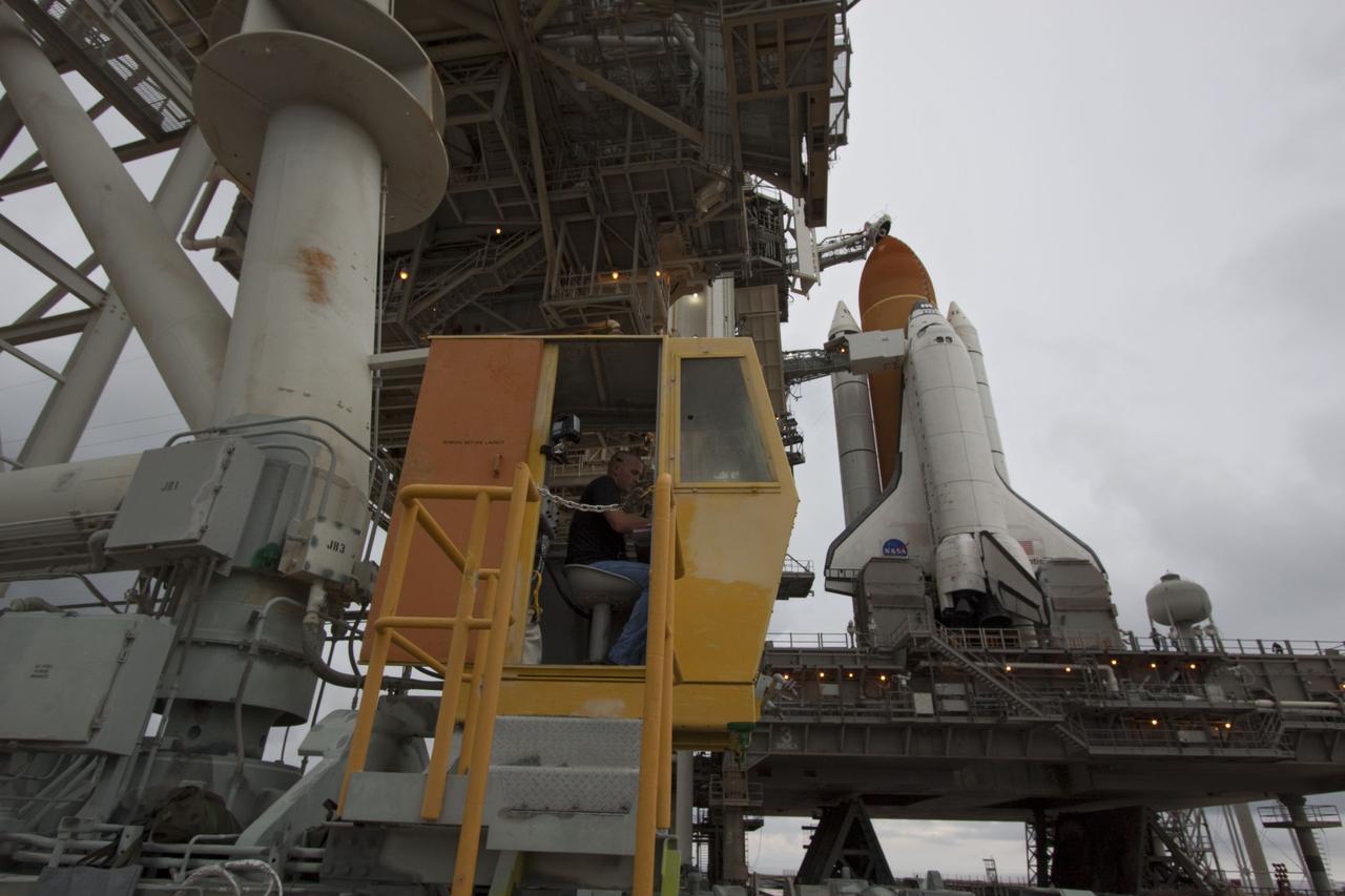 CAPE CANAVERAL, Fla. -- A worker in the control booth on Launch Pad 39A at NASA's Kennedy Space Center in Florida monitor's the progress of the rotating service structure  (RSS) as it is rolled back revealing space shuttle Atlantis. The structure provides weather protection and access to the shuttle while it awaits liftoff on the pad. RSS "rollback" marks a major milestone in Atlantis' STS-135 mission countdown.        Atlantis and its crew of four; Commander Chris Ferguson, Pilot Doug Hurley and Mission Specialists Sandy Magnus and Rex Walheim, are scheduled to lift off at 11:26 a.m. EDT on July 8 to deliver the Raffaello multi-purpose logistics module packed with supplies and spare parts to the International Space Station. Atlantis also will fly the Robotic Refueling Mission experiment that will investigate the potential for robotically refueling existing satellites in orbit. In addition, Atlantis will return with a failed ammonia pump module to help NASA better understand the failure mechanism and improve pump designs for future systems. STS-135 will be the 33rd flight of Atlantis, the 37th shuttle mission to the space station, and the 135th and final mission of NASA's Space Shuttle Program. For more information visit, www.nasa.gov/mission_pages/shuttle/shuttlemissions/sts135/index.html. Photo credit: NASA/Troy Cryder