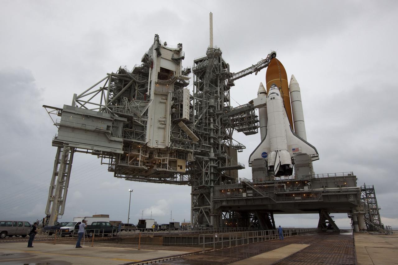 CAPE CANAVERAL, Fla. -- Employees check out space shuttle Atlantis after it was uncovered on Launch Pad 39A at NASA's Kennedy Space Center in Florida following the move of the rotating service structure (RSS). The structure provides weather protection and access to the shuttle while it awaits liftoff on the pad. RSS "rollback" marks a major milestone in Atlantis' STS-135 mission countdown.        Atlantis and its crew of four; Commander Chris Ferguson, Pilot Doug Hurley and Mission Specialists Sandy Magnus and Rex Walheim, are scheduled to lift off at 11:26 a.m. EDT on July 8 to deliver the Raffaello multi-purpose logistics module packed with supplies and spare parts to the International Space Station. Atlantis also will fly the Robotic Refueling Mission experiment that will investigate the potential for robotically refueling existing satellites in orbit. In addition, Atlantis will return with a failed ammonia pump module to help NASA better understand the failure mechanism and improve pump designs for future systems. STS-135 will be the 33rd flight of Atlantis, the 37th shuttle mission to the space station, and the 135th and final mission of NASA's Space Shuttle Program. For more information visit, www.nasa.gov/mission_pages/shuttle/shuttlemissions/sts135/index.html. Photo credit: NASA/Troy Cryder