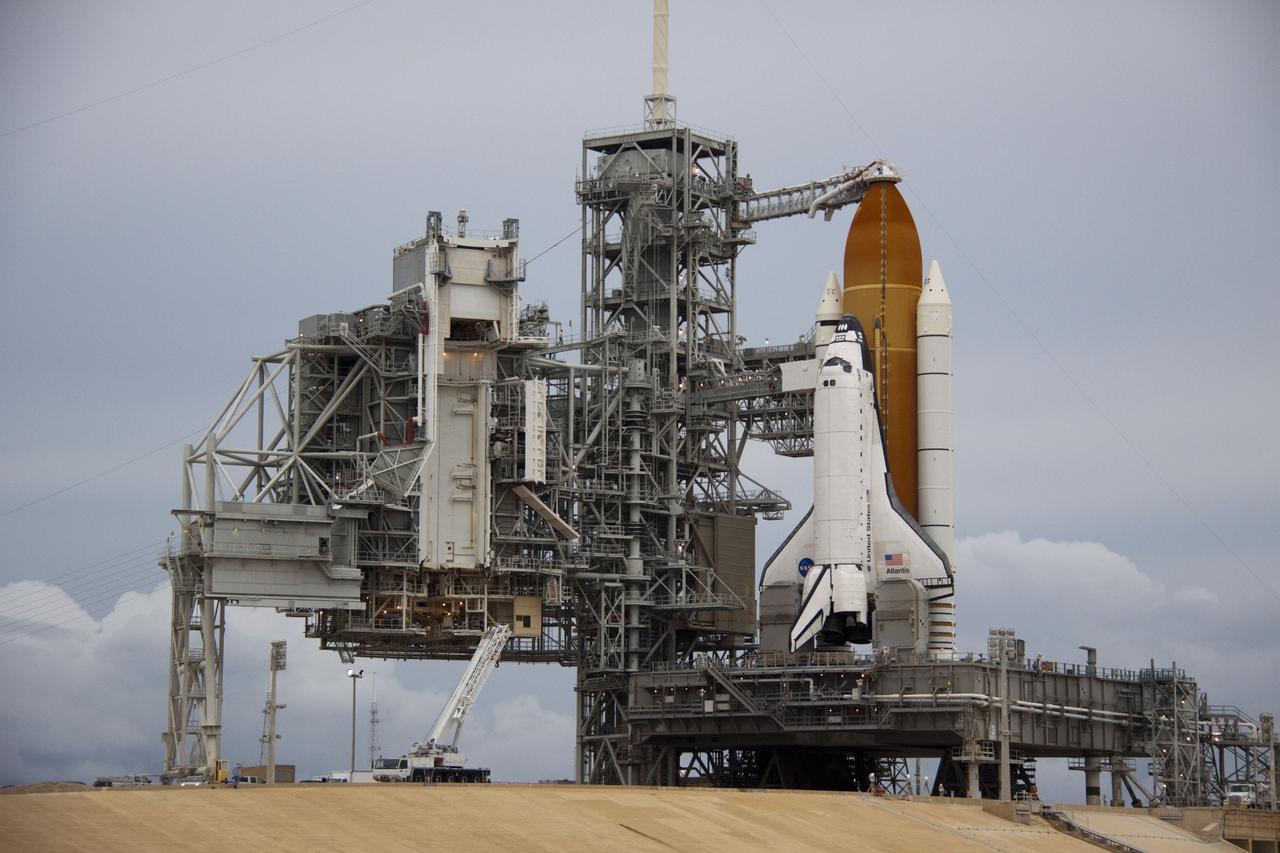 CAPE CANAVERAL, Fla. -- Space shuttle Atlantis is revealed on Launch Pad 39A at NASA's Kennedy Space Center in Florida following the move of the rotating service structure (RSS). The structure provides weather protection and access to the shuttle while it awaits liftoff on the pad. RSS "rollback" marks a major milestone in Atlantis' STS-135 mission countdown.            Atlantis and its crew of four; Commander Chris Ferguson, Pilot Doug Hurley and Mission Specialists Sandy Magnus and Rex Walheim, are scheduled to lift off at 11:26 a.m. EDT on July 8 to deliver the Raffaello multi-purpose logistics module packed with supplies and spare parts to the International Space Station. Atlantis also will fly the Robotic Refueling Mission experiment that will investigate the potential for robotically refueling existing satellites in orbit. In addition, Atlantis will return with a failed ammonia pump module to help NASA better understand the failure mechanism and improve pump designs for future systems. STS-135 will be the 33rd flight of Atlantis, the 37th shuttle mission to the space station, and the 135th and final mission of NASA's Space Shuttle Program. For more information visit, www.nasa.gov/mission_pages/shuttle/shuttlemissions/sts135/index.html. Photo credit: NASA/Troy Cryder