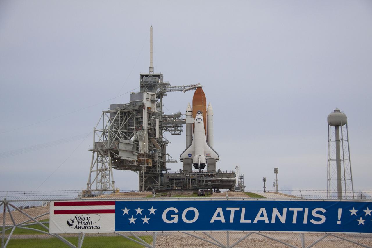 CAPE CANAVERAL, Fla. -- Space shuttle Atlantis is revealed on Launch Pad 39A at NASA's Kennedy Space Center in Florida following the move of the rotating service structure (RSS). The structure provides weather protection and access to the shuttle while it awaits liftoff on the pad. RSS "rollback" marks a major milestone in Atlantis' STS-135 mission countdown. In front of the pad a banner proclaims the sentiments of Kennedy's work force.          Atlantis and its crew of four; Commander Chris Ferguson, Pilot Doug Hurley and Mission Specialists Sandy Magnus and Rex Walheim, are scheduled to lift off at 11:26 a.m. EDT on July 8 to deliver the Raffaello multi-purpose logistics module packed with supplies and spare parts to the International Space Station. Atlantis also will fly the Robotic Refueling Mission experiment that will investigate the potential for robotically refueling existing satellites in orbit. In addition, Atlantis will return with a failed ammonia pump module to help NASA better understand the failure mechanism and improve pump designs for future systems. STS-135 will be the 33rd flight of Atlantis, the 37th shuttle mission to the space station, and the 135th and final mission of NASA's Space Shuttle Program. For more information visit, www.nasa.gov/mission_pages/shuttle/shuttlemissions/sts135/index.html. Photo credit: NASA/Troy Cryder
