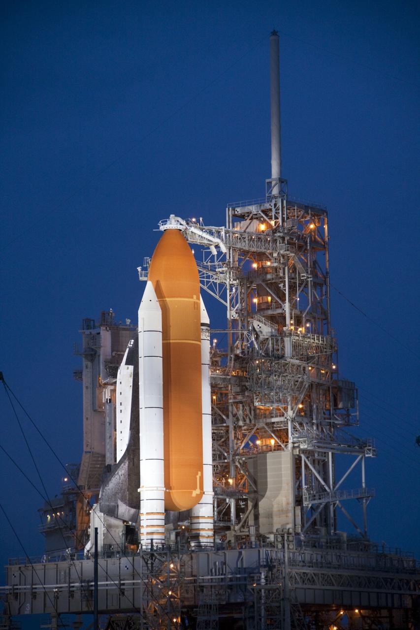 CAPE CANAVERAL, Fla. -- Space shuttle Atlantis is revealed on Launch Pad 39A at NASA's Kennedy Space Center in Florida bathed in xenon lights following the move of the rotating service structure (RSS). The structure provides weather protection and access to the shuttle while it awaits liftoff on the pad. RSS retract marks a major milestone in Atlantis' STS-135 mission countdown.              Atlantis and its crew of four; Commander Chris Ferguson, Pilot Doug Hurley, Mission Specialists Sandy Magnus and Rex Walheim will lift off at 11:26 a.m. EDT on July 8 to deliver the Raffaello multi-purpose logistics module packed with supplies and spare parts for the International Space Station. Atlantis also will fly the Robotic Refueling Mission experiment that will investigate the potential for robotically refueling existing satellites in orbit. In addition, Atlantis will return with a failed ammonia pump module to help NASA better understand the failure mechanism and improve pump designs for future systems. STS-135 is the 33rd flight of Atlantis, the 37th shuttle mission to the space station, and the 135th and final mission of NASA's Space Shuttle Program. For more information, visit www.nasa.gov/mission_pages/shuttle/shuttlemissions/sts135/index.html. Photo credit: Jim Grossmann