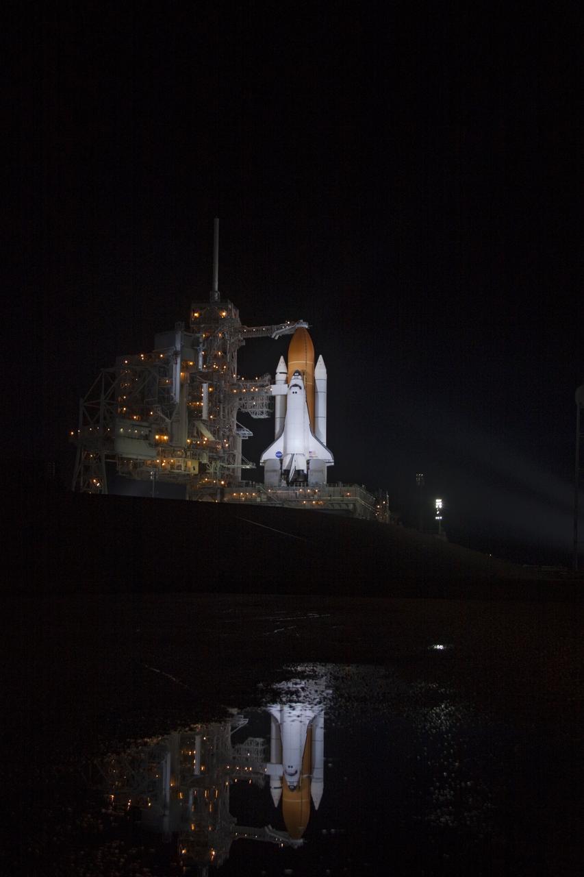 CAPE CANAVERAL, Fla. -- At Launch Pad 39A at NASA's Kennedy Space Center in Florida space shuttle Atlantis is reflected in a pond near the pad after the retraction of the rotating service structure (RSS). The structure provides weather protection and access to the shuttle while it awaits liftoff on the pad. RSS retract marks a major milestone in Atlantis' STS-135 mission countdown.        Atlantis and its crew of four; Commander Chris Ferguson, Pilot Doug Hurley, Mission Specialists Sandy Magnus and Rex Walheim will lift off at 11:26 a.m. EDT on July 8 to deliver the Raffaello multi-purpose logistics module packed with supplies and spare parts for the International Space Station. Atlantis also will fly the Robotic Refueling Mission experiment that will investigate the potential for robotically refueling existing satellites in orbit. In addition, Atlantis will return with a failed ammonia pump module to help NASA better understand the failure mechanism and improve pump designs for future systems. STS-135 is the 33rd flight of Atlantis, the 37th shuttle mission to the space station, and the 135th and final mission of NASA's Space Shuttle Program. For more information, visit www.nasa.gov/mission_pages/shuttle/shuttlemissions/sts135/index.html. Photo credit: Jim Grossmann