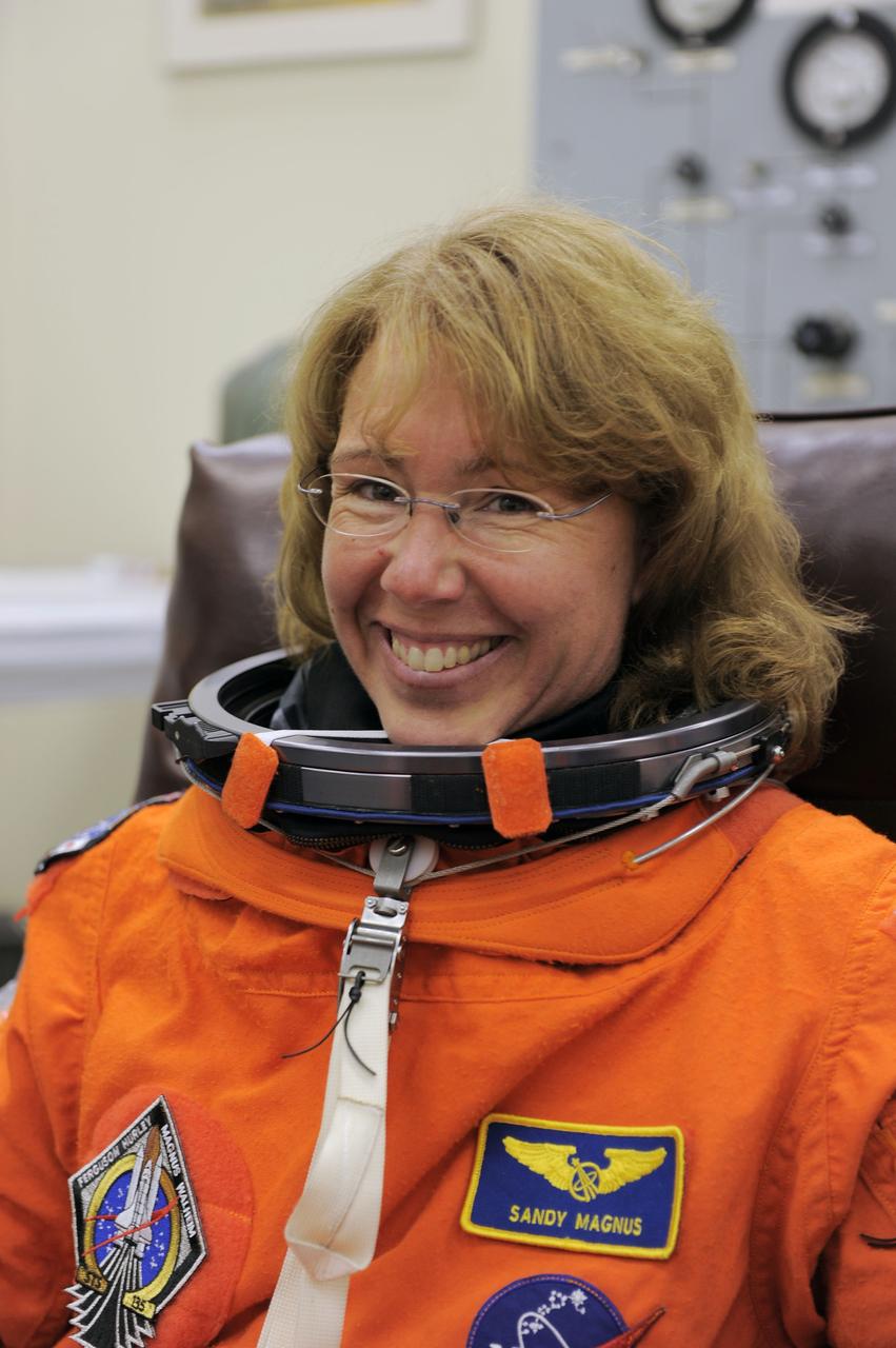 CAPE CANAVERAL, Fla. -- STS-135 Mission Specialist Sandy Magnus dons her launch-and-entry suit in the Operations and Checkout Building at NASA's Kennedy Space Center in Florida. Magnus is one of the final four astronauts to launch aboard a space shuttle. She has launched aboard a shuttle twice and most recently spent time aboard the International Space Station as an Expedition 18 crew member from November 2008 to March 2009. STS-135 is scheduled to lift off aboard space shuttle Atlantis at 11:26 a.m. EDT on July 8 for a mission to the International Space Station.          STS-135 will deliver the Raffaello multi-purpose logistics module packed with supplies and spare parts for the orbiting outpost. Atlantis also will fly the Robotic Refueling Mission experiment that will investigate the potential for robotically refueling existing satellites in orbit. In addition, Atlantis will return with a failed ammonia pump module to help NASA better understand the failure mechanism and improve pump designs for future systems. STS-135 will be the 33rd flight of Atlantis, the 37th shuttle mission to the space station, and the 135th and final mission of NASA's Space Shuttle Program. For more information visit, www.nasa.gov/mission_pages/shuttle/shuttlemissions/sts135/index.html. Photo credit: NASA/Kim Shiflett