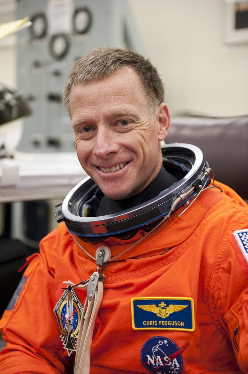 CAPE CANAVERAL, Fla. -- STS-135 Commander Chris Ferguson dons his launch-and-entry suit in the Operations and Checkout Building at NASA's Kennedy Space Center in Florida. Ferguson is one of the final four astronauts to launch aboard a space shuttle. He is a retired U.S. Navy captain who already has logged nearly a month in space during two previous shuttle flights. STS-135 is scheduled to lift off aboard space shuttle Atlantis at 11:26 a.m. EDT on July 8 for a mission to the International Space Station.    STS-135 will deliver the Raffaello multi-purpose logistics module packed with supplies and spare parts for the orbiting outpost. Atlantis also will fly the Robotic Refueling Mission experiment that will investigate the potential for robotically refueling existing satellites in orbit. In addition, Atlantis will return with a failed ammonia pump module to help NASA better understand the failure mechanism and improve pump designs for future systems. STS-135 will be the 33rd flight of Atlantis, the 37th shuttle mission to the space station, and the 135th and final mission of NASA's Space Shuttle Program. For more information visit, www.nasa.gov/mission_pages/shuttle/shuttlemissions/sts135/index.html. Photo credit: NASA/Kim Shiflett