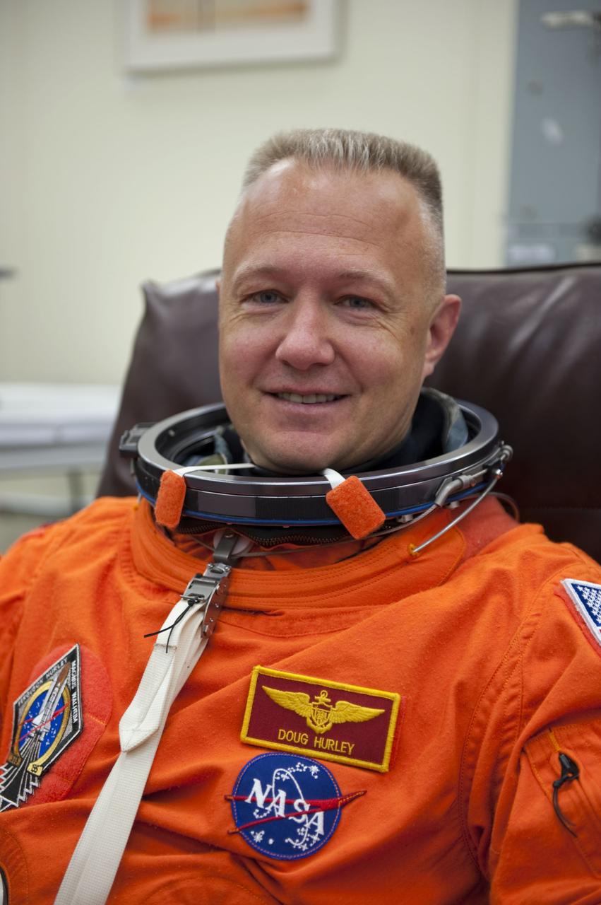 CAPE CANAVERAL, Fla. -- STS-135 Pilot Doug Hurley dons his launch-and-entry suit in the Operations and Checkout Building at NASA's Kennedy Space Center in Florida. Hurley is one of the final four astronauts to launch aboard a space shuttle. He is a colonel in the U.S. Marine Corps with one shuttle mission under his belt -- STS-127 aboard Endeavour. STS-135 is scheduled to lift off aboard space shuttle Atlantis at 11:26 a.m. EDT on July 8 for a mission to the International Space Station.      STS-135 will deliver the Raffaello multi-purpose logistics module packed with supplies and spare parts for the orbiting outpost. Atlantis also will fly the Robotic Refueling Mission experiment that will investigate the potential for robotically refueling existing satellites in orbit. In addition, Atlantis will return with a failed ammonia pump module to help NASA better understand the failure mechanism and improve pump designs for future systems. STS-135 will be the 33rd flight of Atlantis, the 37th shuttle mission to the space station, and the 135th and final mission of NASA's Space Shuttle Program. For more information visit, www.nasa.gov/mission_pages/shuttle/shuttlemissions/sts135/index.html. Photo credit: NASA/Kim Shiflett
