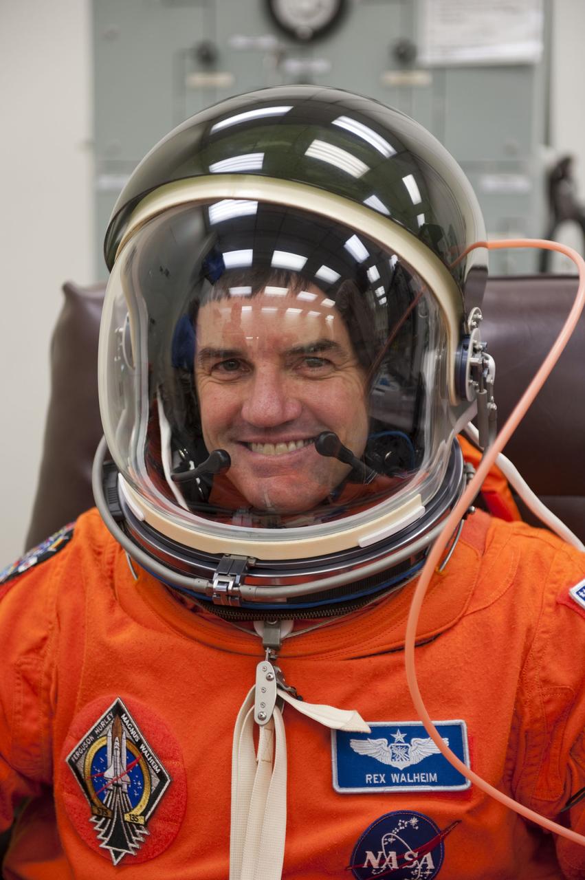 CAPE CANAVERAL, Fla. -- STS-135 Mission Specialist Rex Walheim dons his launch-and-entry suit and helmet in the Operations and Checkout Building at NASA's Kennedy Space Center in Florida. Walheim is one of the final four astronauts to launch aboard a space shuttle. All three of Walheim's missions -- STS-110, STS-122 and now STS-135 -- will have been aboard space shuttle Atlantis. STS-135 is scheduled to lift off aboard Atlantis at 11:26 a.m. EDT on July 8 for a mission to the International Space Station.      STS-135 will deliver the Raffaello multi-purpose logistics module packed with supplies and spare parts for the orbiting outpost. Atlantis also will fly the Robotic Refueling Mission experiment that will investigate the potential for robotically refueling existing satellites in orbit. In addition, Atlantis will return with a failed ammonia pump module to help NASA better understand the failure mechanism and improve pump designs for future systems. STS-135 will be the 33rd flight of Atlantis, the 37th shuttle mission to the space station, and the 135th and final mission of NASA's Space Shuttle Program. For more information visit, www.nasa.gov/mission_pages/shuttle/shuttlemissions/sts135/index.html. Photo credit: NASA/Kim Shiflett