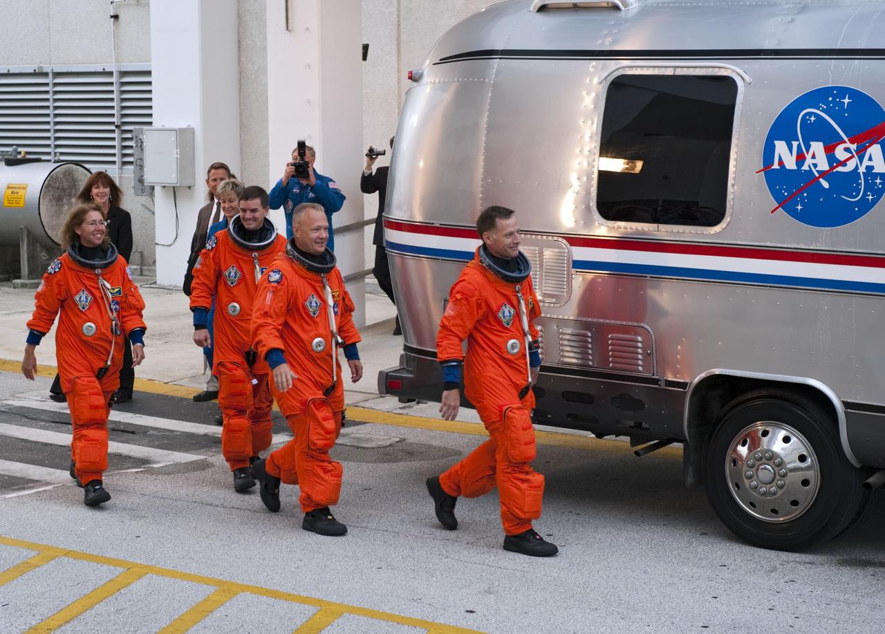 CAPE CANAVERAL, Fla. -- Dressed in their bright-orange launch-and-entry suits, the final four astronauts to launch aboard a space shuttle exit the Astronaut Crew Quarters in the Operations and Checkout Building at NASA's Kennedy Space Center in Florida. STS-135 Commander Chris Ferguson is followed by Pilot Doug Hurley and Mission Specialists Rex Walheim and Sandy Magnus. The astronauts, who will head to Launch Pad 39A aboard the silver Astrovan, are scheduled to lift off aboard space shuttle Atlantis at 11:26 a.m. EDT on July 8 for their mission to the International Space Station.    STS-135 will deliver the Raffaello multi-purpose logistics module packed with supplies and spare parts for the orbiting outpost. Atlantis also will fly the Robotic Refueling Mission experiment that will investigate the potential for robotically refueling existing satellites in orbit. In addition, Atlantis will return with a failed ammonia pump module to help NASA better understand the failure mechanism and improve pump designs for future systems. STS-135 will be the 33rd flight of Atlantis, the 37th shuttle mission to the space station, and the 135th and final mission of NASA's Space Shuttle Program. For more information, visit www.nasa.gov/mission_pages/shuttle/shuttlemissions/sts135/index.html. Photo credit: NASA/Kim Shiflett