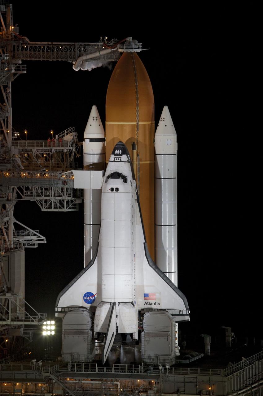 CAPE CANAVERAL, Fla. -- Space shuttle Atlantis, attached to its bright-orange external fuel tank and twin solid rocket boosters, is bathed in xenon lights and takes center stage on Launch Pad 39A at NASA's Kennedy Space Center in Florida in this aerial image taken from a NASA helicopter. Atlantis and its crew of four -- Commander Chris Ferguson, Pilot Doug Hurley and Mission Specialists Sandy Magnus and Rex Walheim -- are scheduled to lift off at 11:26 a.m. EDT on July 8 to deliver the Raffaello multi-purpose logistics module packed with supplies and spare parts to the International Space Station. Atlantis also will fly the Robotic Refueling Mission experiment that will investigate the potential for robotically refueling existing satellites in orbit. In addition, Atlantis will return with a failed ammonia pump module to help NASA better understand the failure mechanism and improve pump designs for future systems. STS-135 will be the 33rd flight of Atlantis, the 37th shuttle mission to the space station, and the 135th and final mission of NASA's Space Shuttle Program. For more information, visit www.nasa.gov/mission_pages/shuttle/shuttlemissions/sts135/index.html. Photo credit: NASA/Frank Michaux