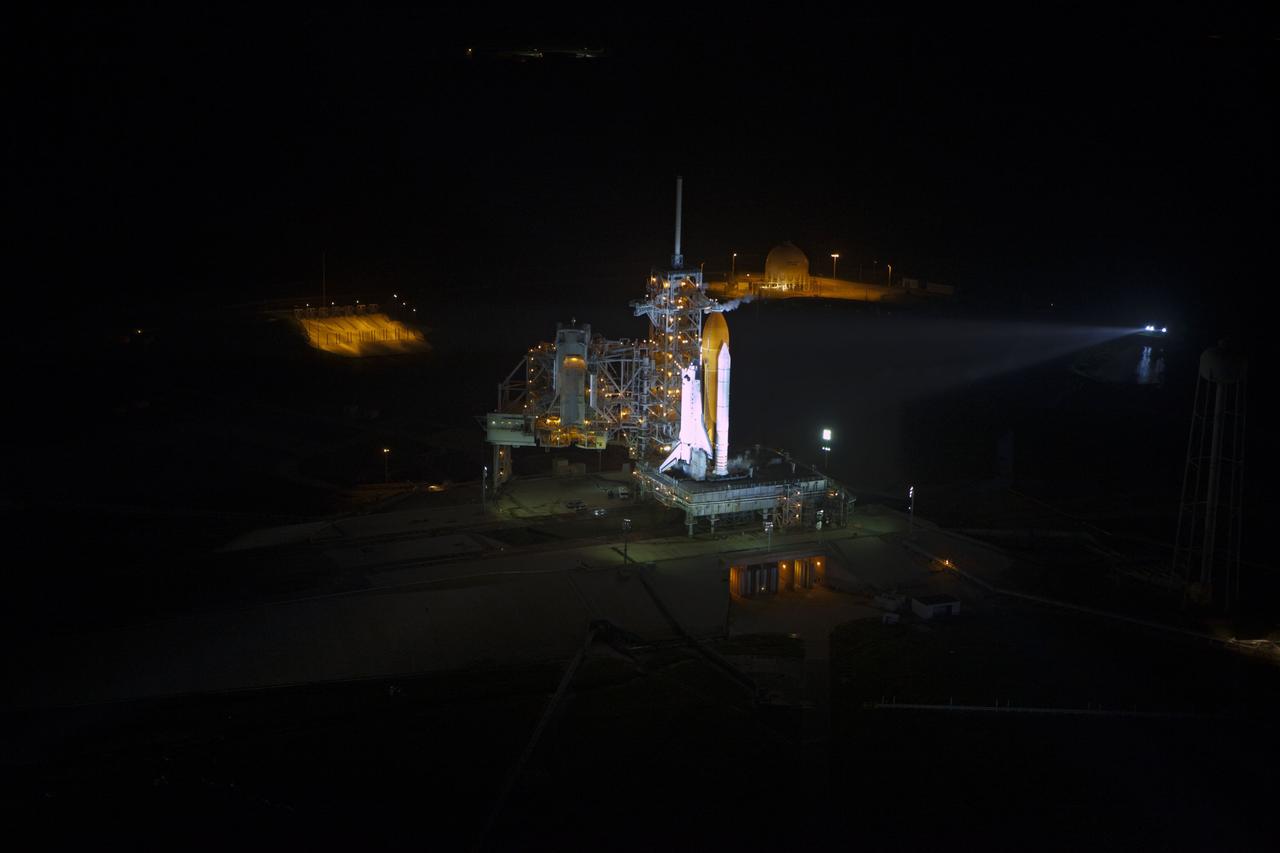 CAPE CANAVERAL, Fla. -- Space shuttle Atlantis, attached to its bright-orange external fuel tank and twin solid rocket boosters, is bathed in xenon lights and takes center stage on Launch Pad 39A at NASA's Kennedy Space Center in Florida in this aerial image taken from a NASA helicopter. Atlantis and its crew of four -- Commander Chris Ferguson, Pilot Doug Hurley and Mission Specialists Sandy Magnus and Rex Walheim -- are scheduled to lift off at 11:26 a.m. EDT on July 8 to deliver the Raffaello multi-purpose logistics module packed with supplies and spare parts to the International Space Station. Atlantis also will fly the Robotic Refueling Mission experiment that will investigate the potential for robotically refueling existing satellites in orbit. In addition, Atlantis will return with a failed ammonia pump module to help NASA better understand the failure mechanism and improve pump designs for future systems. STS-135 will be the 33rd flight of Atlantis, the 37th shuttle mission to the space station, and the 135th and final mission of NASA's Space Shuttle Program. For more information, visit www.nasa.gov/mission_pages/shuttle/shuttlemissions/sts135/index.html. Photo credit: NASA/Frank Michaux