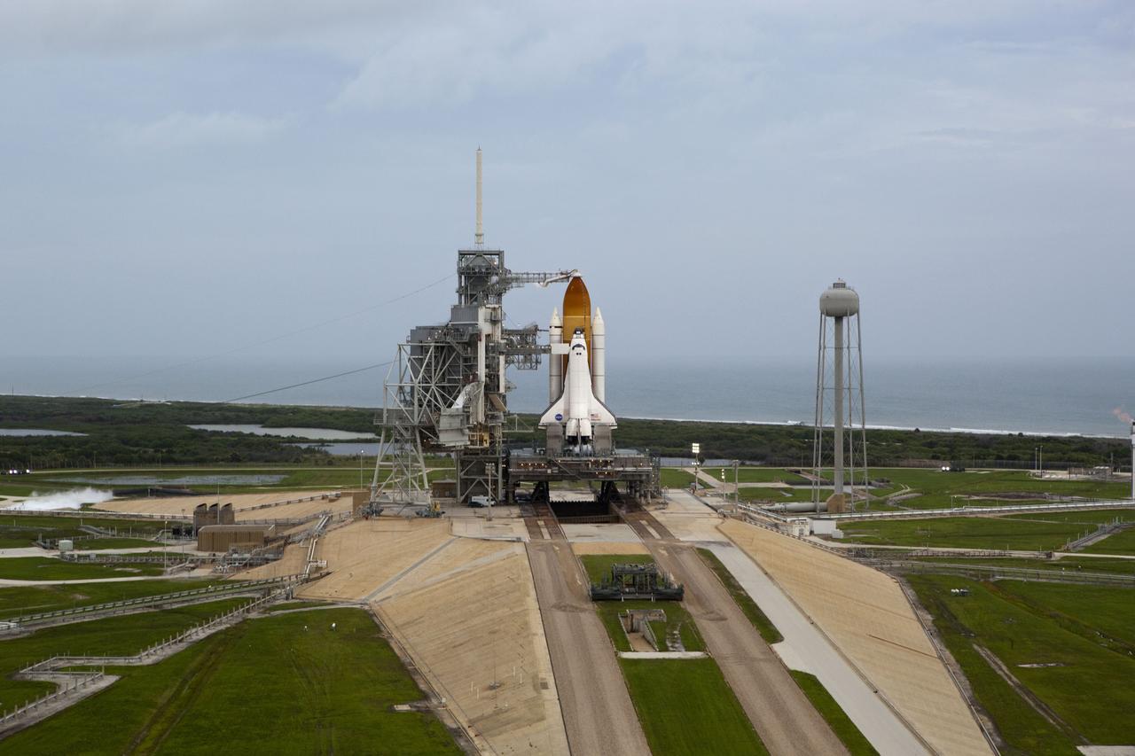 CAPE CANAVERAL, Fla. -- Space shuttle Atlantis, attached to its bright-orange external fuel tank and twin solid rocket boosters, takes center stage on its seaside launch pad at NASA's Kennedy Space Center in Florida in this aerial image taken from a NASA helicopter. Atlantis and its crew of four -- Commander Chris Ferguson, Pilot Doug Hurley and Mission Specialists Sandy Magnus and Rex Walheim -- are scheduled to lift off at 11:26 a.m. EDT on July 8 to deliver the Raffaello multi-purpose logistics module packed with supplies and spare parts to the International Space Station. Atlantis also will fly the Robotic Refueling Mission experiment that will investigate the potential for robotically refueling existing satellites in orbit. In addition, Atlantis will return with a failed ammonia pump module to help NASA better understand the failure mechanism and improve pump designs for future systems. STS-135 will be the 33rd flight of Atlantis, the 37th shuttle mission to the space station, and the 135th and final mission of NASA's Space Shuttle Program. For more information, visit www.nasa.gov/mission_pages/shuttle/shuttlemissions/sts135/index.html. Photo credit: NASA/Frank Michaux