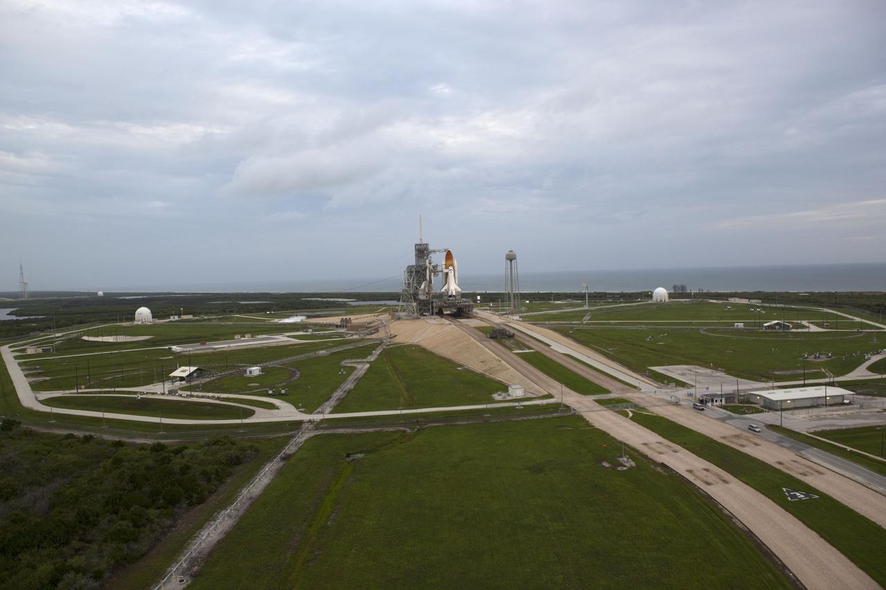CAPE CANAVERAL, Fla. -- Space shuttle Atlantis, attached to its bright-orange external fuel tank and twin solid rocket boosters, takes center stage on its seaside launch pad at NASA's Kennedy Space Center in Florida in this aerial image taken from a NASA helicopter. Atlantis and its crew of four -- Commander Chris Ferguson, Pilot Doug Hurley and Mission Specialists Sandy Magnus and Rex Walheim -- are scheduled to lift off at 11:26 a.m. EDT on July 8 to deliver the Raffaello multi-purpose logistics module packed with supplies and spare parts to the International Space Station. Atlantis also will fly the Robotic Refueling Mission experiment that will investigate the potential for robotically refueling existing satellites in orbit. In addition, Atlantis will return with a failed ammonia pump module to help NASA better understand the failure mechanism and improve pump designs for future systems. STS-135 will be the 33rd flight of Atlantis, the 37th shuttle mission to the space station, and the 135th and final mission of NASA's Space Shuttle Program. For more information, visit www.nasa.gov/mission_pages/shuttle/shuttlemissions/sts135/index.html. Photo credit: NASA/Frank Michaux