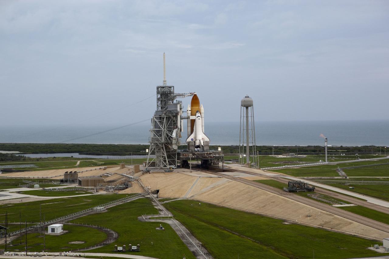 CAPE CANAVERAL, Fla. -- Space shuttle Atlantis, attached to its bright-orange external fuel tank and twin solid rocket boosters, takes center stage on its seaside launch pad at NASA's Kennedy Space Center in Florida in this aerial image taken from a NASA helicopter. Atlantis and its crew of four -- Commander Chris Ferguson, Pilot Doug Hurley and Mission Specialists Sandy Magnus and Rex Walheim -- are scheduled to lift off at 11:26 a.m. EDT on July 8 to deliver the Raffaello multi-purpose logistics module packed with supplies and spare parts to the International Space Station. Atlantis also will fly the Robotic Refueling Mission experiment that will investigate the potential for robotically refueling existing satellites in orbit. In addition, Atlantis will return with a failed ammonia pump module to help NASA better understand the failure mechanism and improve pump designs for future systems. STS-135 will be the 33rd flight of Atlantis, the 37th shuttle mission to the space station, and the 135th and final mission of NASA's Space Shuttle Program. For more information, visit www.nasa.gov/mission_pages/shuttle/shuttlemissions/sts135/index.html. Photo credit: NASA/Frank Michaux