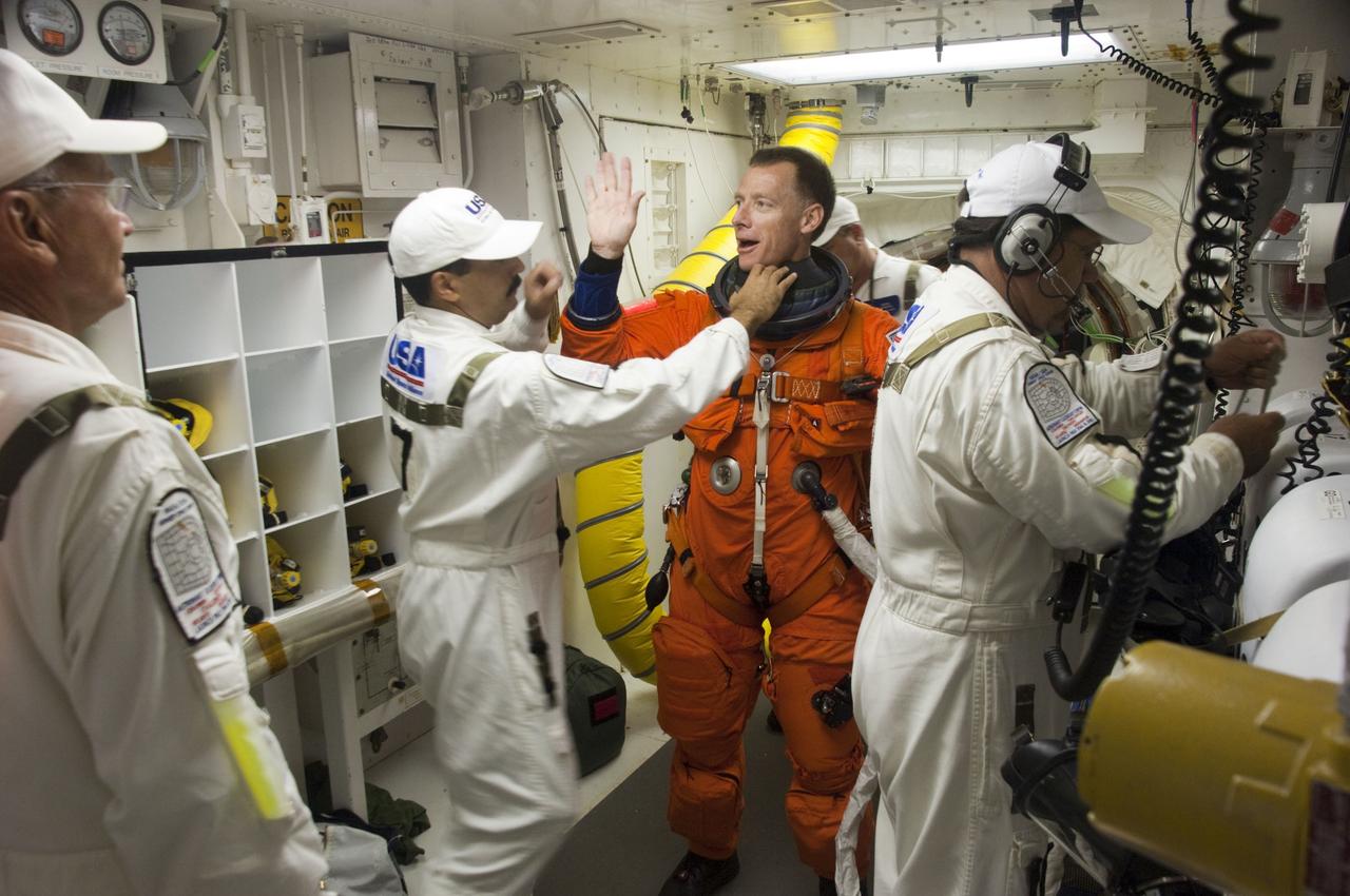 CAPE CANAVERAL, Fla. -- The Closeout Crew helps STS-135 Commander Chris Ferguson prepare to enter space shuttle Atlantis from the White Room of Launch Pad 39A at NASA's Kennedy Space Center in Florida. Ferguson is one of the final four astronauts to launch aboard a space shuttle. He is a retired U.S. Navy captain who already has logged nearly a month in space during two previous shuttle flights. STS-135 is scheduled to lift off at 11:26 a.m. EDT on July 8 for a mission to the International Space Station.     STS-135 will deliver the Raffaello multi-purpose logistics module packed with supplies and spare parts for the International Space Station. Atlantis also will fly the Robotic Refueling Mission experiment that will investigate the potential for robotically refueling existing satellites in orbit. In addition, Atlantis will return with a failed ammonia pump module to help NASA better understand the failure mechanism and improve pump designs for future systems. STS-135 will be the 33rd flight of Atlantis, the 37th shuttle mission to the space station, and the 135th and final mission of NASA's Space Shuttle Program. For more information, visit www.nasa.gov/mission_pages/shuttle/shuttlemissions/sts135/index.html. Photo credit: NASA/Sandra Joseph and Kevin O'Connell