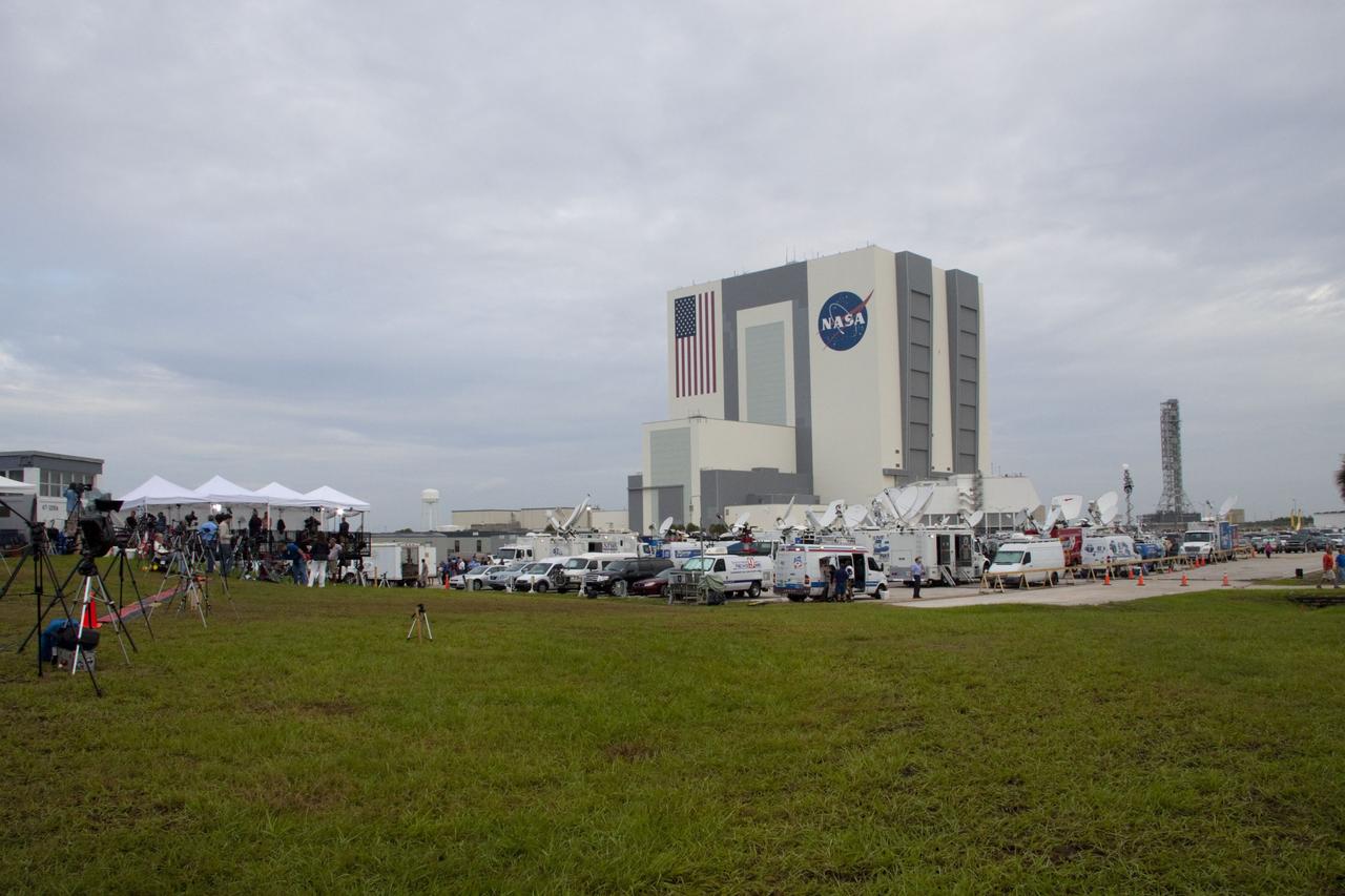 CAPE CANAVERAL, Fla. -- Media from around the globe gather on the grounds of the Press Site at NASA's Kennedy Space Center in Florida to photograph and cover the prelaunch activities and lift off of space shuttle Atlantis on its STS-135 mission to the International Space Station. Dozens of satellite news vehicles can be seen in the parking lot while the massive Vehicle Assembly Building towers above in the background.          Atlantis began its final flight, with Commander Chris Ferguson, Pilot Doug Hurley and Mission Specialists Sandy Magnus and Rex Walheim on board, at 11:29 a.m. EDT July 8 to deliver the Raffaello multi-purpose logistics module packed with supplies and spare parts to the station. Also in Atlantis' payload bay is the Robotic Refueling Mission experiment that will investigate the potential for robotically refueling existing satellites in orbit. In addition, Atlantis will return with a failed ammonia pump module to help NASA better understand the failure mechanism and improve pump designs for future systems. STS-135 is the 33rd flight of Atlantis, the 37th shuttle mission to the space station, and the 135th and final mission of NASA's Space Shuttle Program. For more information, visit www.nasa.gov/mission_pages/shuttle/shuttlemissions/sts135/index.html. Photo credit: NASA/Jim Grossmann