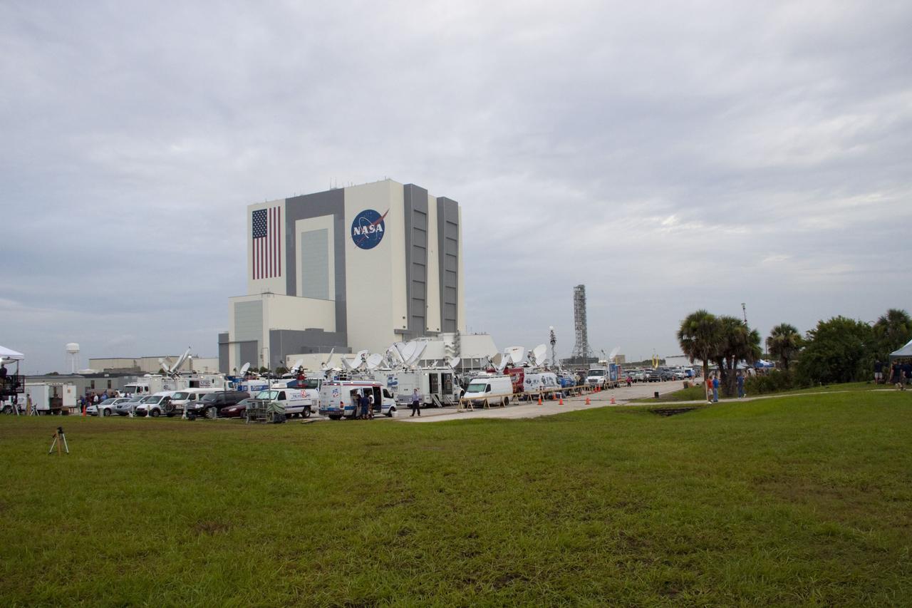 CAPE CANAVERAL, Fla. -- Media from around the globe gather on the grounds of the Press Site at NASA's Kennedy Space Center in Florida to photograph and cover the prelaunch activities and lift off of space shuttle Atlantis on its STS-135 mission to the International Space Station. Dozens of satellite news vehicles can be seen in the parking lot while the massive Vehicle Assembly Building towers above in the background.          Atlantis began its final flight, with Commander Chris Ferguson, Pilot Doug Hurley and Mission Specialists Sandy Magnus and Rex Walheim on board, at 11:29 a.m. EDT July 8 to deliver the Raffaello multi-purpose logistics module packed with supplies and spare parts to the station. Also in Atlantis' payload bay is the Robotic Refueling Mission experiment that will investigate the potential for robotically refueling existing satellites in orbit. In addition, Atlantis will return with a failed ammonia pump module to help NASA better understand the failure mechanism and improve pump designs for future systems. STS-135 is the 33rd flight of Atlantis, the 37th shuttle mission to the space station, and the 135th and final mission of NASA's Space Shuttle Program. For more information, visit www.nasa.gov/mission_pages/shuttle/shuttlemissions/sts135/index.html. Photo credit: NASA/Jim Grossmann
