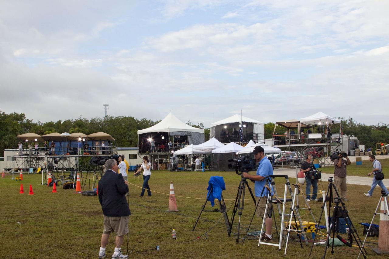 CAPE CANAVERAL, Fla. -- Media from around the globe gather at the Press Site in their respective tents at NASA's Kennedy Space Center in Florida to photograph and cover the prelaunch activities and lift off of space shuttle Atlantis on its STS-135 mission to the International Space Station.        Atlantis began its final flight, with Commander Chris Ferguson, Pilot Doug Hurley and Mission Specialists Sandy Magnus and Rex Walheim on board, at 11:29 a.m. EDT July 8 to deliver the Raffaello multi-purpose logistics module packed with supplies and spare parts to the station. Also in Atlantis' payload bay is the Robotic Refueling Mission experiment that will investigate the potential for robotically refueling existing satellites in orbit. In addition, Atlantis will return with a failed ammonia pump module to help NASA better understand the failure mechanism and improve pump designs for future systems. STS-135 is the 33rd flight of Atlantis, the 37th shuttle mission to the space station, and the 135th and final mission of NASA's Space Shuttle Program. For more information, visit www.nasa.gov/mission_pages/shuttle/shuttlemissions/sts135/index.html. Photo credit: NASA/Jim Grossmann