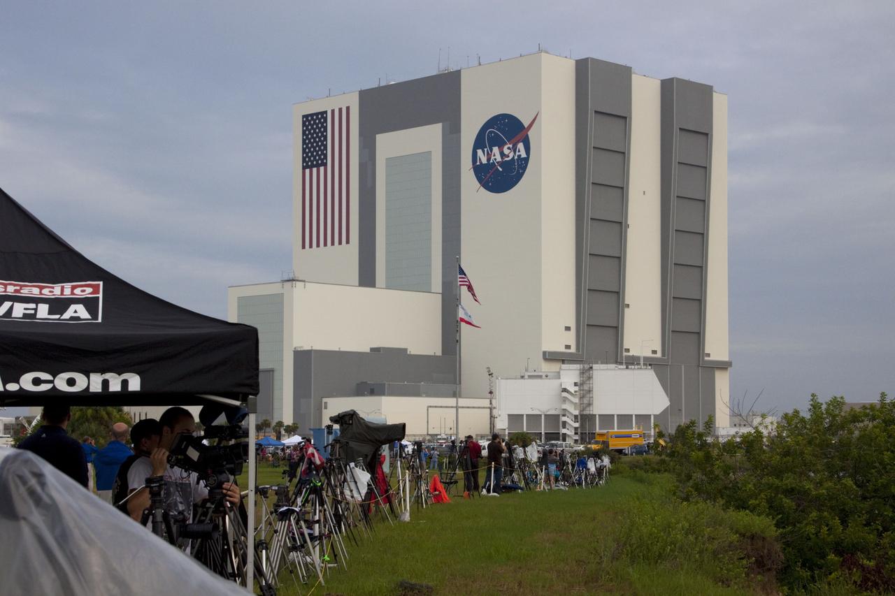 CAPE CANAVERAL, Fla. -- Media from around the globe gather on the grounds of the Press Site at NASA's Kennedy Space Center in Florida to photograph and cover the prelaunch activities and lift off of space shuttle Atlantis on its STS-135 mission to the International Space Station. Seen towering above is the massive Vehicle Assembly Building.          Atlantis began its final flight, with Commander Chris Ferguson, Pilot Doug Hurley and Mission Specialists Sandy Magnus and Rex Walheim on board, at 11:29 a.m. EDT July 8 to deliver the Raffaello multi-purpose logistics module packed with supplies and spare parts to the station. Also in Atlantis' payload bay is the Robotic Refueling Mission experiment that will investigate the potential for robotically refueling existing satellites in orbit. In addition, Atlantis will return with a failed ammonia pump module to help NASA better understand the failure mechanism and improve pump designs for future systems. STS-135 is the 33rd flight of Atlantis, the 37th shuttle mission to the space station, and the 135th and final mission of NASA's Space Shuttle Program. For more information, visit www.nasa.gov/mission_pages/shuttle/shuttlemissions/sts135/index.html. Photo credit: NASA/Jim Grossmann