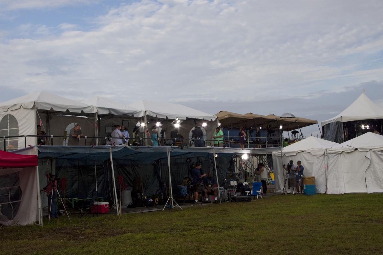 CAPE CANAVERAL, Fla. -- Media from around the globe gather in their respective tents at the Press Site at NASA's Kennedy Space Center in Florida to photograph and cover the prelaunch activities and lift off of space shuttle Atlantis on its STS-135 mission to the International Space Station.          Atlantis began its final flight, with Commander Chris Ferguson, Pilot Doug Hurley and Mission Specialists Sandy Magnus and Rex Walheim on board, at 11:29 a.m. EDT July 8 to deliver the Raffaello multi-purpose logistics module packed with supplies and spare parts to the station. Also in Atlantis' payload bay is the Robotic Refueling Mission experiment that will investigate the potential for robotically refueling existing satellites in orbit. In addition, Atlantis will return with a failed ammonia pump module to help NASA better understand the failure mechanism and improve pump designs for future systems. STS-135 is the 33rd flight of Atlantis, the 37th shuttle mission to the space station, and the 135th and final mission of NASA's Space Shuttle Program. For more information, visit www.nasa.gov/mission_pages/shuttle/shuttlemissions/sts135/index.html. Photo credit: NASA/Jim Grossmann