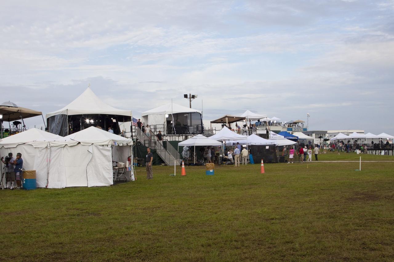 CAPE CANAVERAL, Fla. -- Media from around the globe gather in their respective tents at the Press Site at NASA's Kennedy Space Center in Florida to photograph and cover the prelaunch activities and lift off of space shuttle Atlantis on its STS-135 mission to the International Space Station.          Atlantis began its final flight, with Commander Chris Ferguson, Pilot Doug Hurley and Mission Specialists Sandy Magnus and Rex Walheim on board, at 11:29 a.m. EDT July 8 to deliver the Raffaello multi-purpose logistics module packed with supplies and spare parts to the station. Also in Atlantis' payload bay is the Robotic Refueling Mission experiment that will investigate the potential for robotically refueling existing satellites in orbit. In addition, Atlantis will return with a failed ammonia pump module to help NASA better understand the failure mechanism and improve pump designs for future systems. STS-135 is the 33rd flight of Atlantis, the 37th shuttle mission to the space station, and the 135th and final mission of NASA's Space Shuttle Program. For more information, visit www.nasa.gov/mission_pages/shuttle/shuttlemissions/sts135/index.html. Photo credit: NASA/Jim Grossmann
