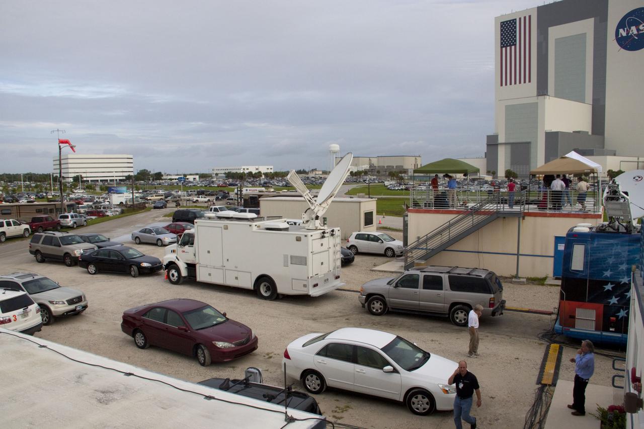 CAPE CANAVERAL, Fla. -- Media from around the globe gather on the grounds of the Press Site at NASA's Kennedy Space Center in Florida to photograph and cover the prelaunch activities and lift off of space shuttle Atlantis on its STS-135 mission to the International Space Station. Seen towering above is the massive Vehicle Assembly Building. Satellite news trucks, trailers and automobiles can be seen in the parking lot with the massive Vehicle Assembly Building towering above.            Atlantis began its final flight, with Commander Chris Ferguson, Pilot Doug Hurley and Mission Specialists Sandy Magnus and Rex Walheim on board, at 11:29 a.m. EDT July 8 to deliver the Raffaello multi-purpose logistics module packed with supplies and spare parts to the station. Also in Atlantis' payload bay is the Robotic Refueling Mission experiment that will investigate the potential for robotically refueling existing satellites in orbit. In addition, Atlantis will return with a failed ammonia pump module to help NASA better understand the failure mechanism and improve pump designs for future systems. STS-135 is the 33rd flight of Atlantis, the 37th shuttle mission to the space station, and the 135th and final mission of NASA's Space Shuttle Program. For more information, visit www.nasa.gov/mission_pages/shuttle/shuttlemissions/sts135/index.html. Photo credit: NASA/Jim Grossmann