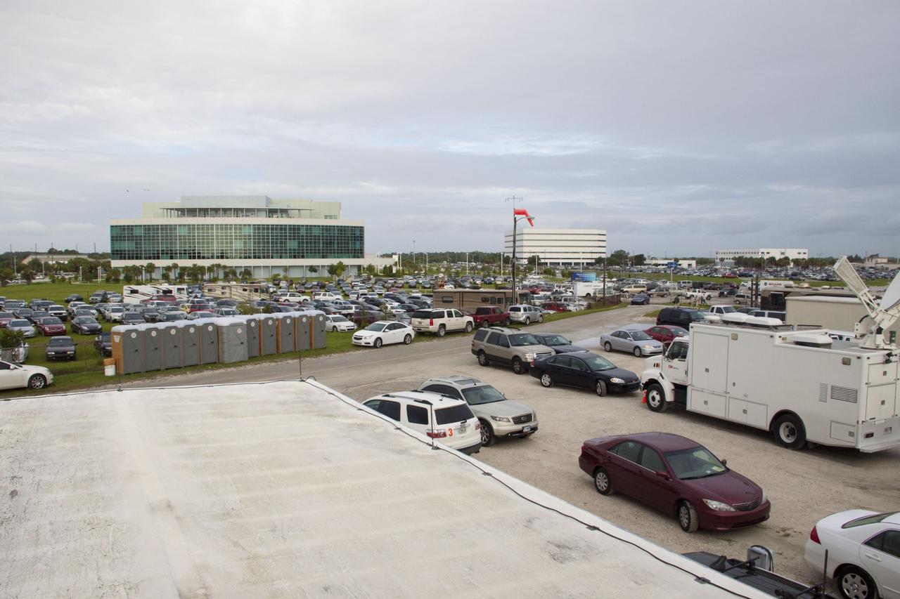 CAPE CANAVERAL, Fla. -- Media from around the globe gather on the grounds of the Press Site at NASA's Kennedy Space Center in Florida to photograph and cover the prelaunch activities and lift off of space shuttle Atlantis on its STS-135 mission to the International Space Station. Satellite news trucks, trailers and automobiles can be seen in the parking lot. In the background is the Operations and Support Building II where VIPs are able to watch the launch from its upper balcony.                Atlantis began its final flight, with Commander Chris Ferguson, Pilot Doug Hurley and Mission Specialists Sandy Magnus and Rex Walheim on board, at 11:29 a.m. EDT July 8 to deliver the Raffaello multi-purpose logistics module packed with supplies and spare parts to the station. Also in Atlantis' payload bay is the Robotic Refueling Mission experiment that will investigate the potential for robotically refueling existing satellites in orbit. In addition, Atlantis will return with a failed ammonia pump module to help NASA better understand the failure mechanism and improve pump designs for future systems. STS-135 is the 33rd flight of Atlantis, the 37th shuttle mission to the space station, and the 135th and final mission of NASA's Space Shuttle Program. For more information, visit www.nasa.gov/mission_pages/shuttle/shuttlemissions/sts135/index.html. Photo credit: NASA/Jim Grossmann