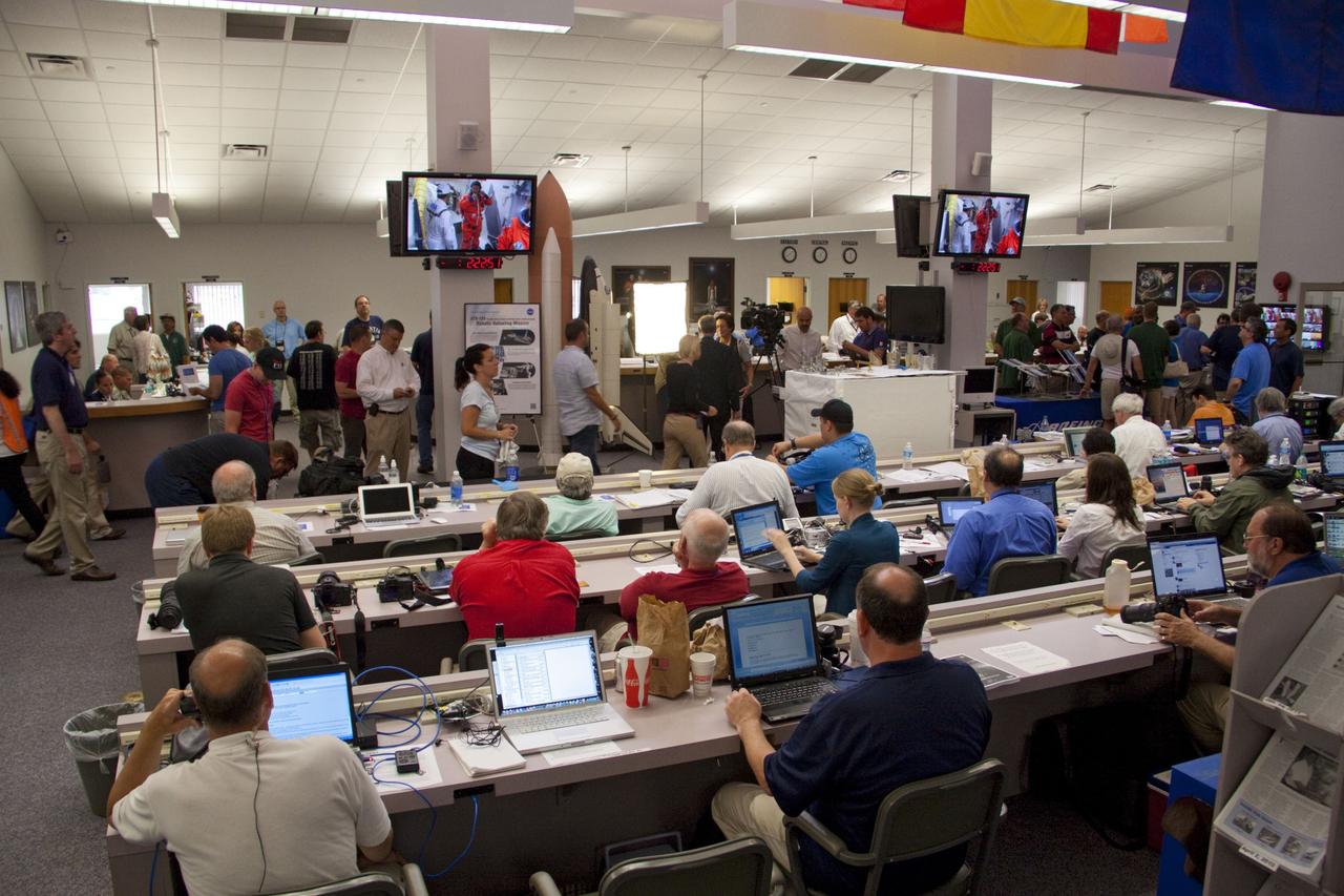 CAPE CANAVERAL, Fla. -- Media from around the globe gather at the NASA News Center at NASA Kennedy Space Center's Press Site in Florida to cover the prelaunch activities and lift off of space shuttle Atlantis on its STS-135 mission to the International Space Station.             Atlantis began its final flight, with Commander Chris Ferguson, Pilot Doug Hurley and Mission Specialists Sandy Magnus and Rex Walheim on board, at 11:29 a.m. EDT July 8 to deliver the Raffaello multi-purpose logistics module packed with supplies and spare parts to the station. Also in Atlantis' payload bay is the Robotic Refueling Mission experiment that will investigate the potential for robotically refueling existing satellites in orbit. In addition, Atlantis will return with a failed ammonia pump module to help NASA better understand the failure mechanism and improve pump designs for future systems. STS-135 is the 33rd flight of Atlantis, the 37th shuttle mission to the space station, and the 135th and final mission of NASA's Space Shuttle Program. For more information, visit www.nasa.gov/mission_pages/shuttle/shuttlemissions/sts135/index.html. Photo credit: NASA/Jim Grossmann