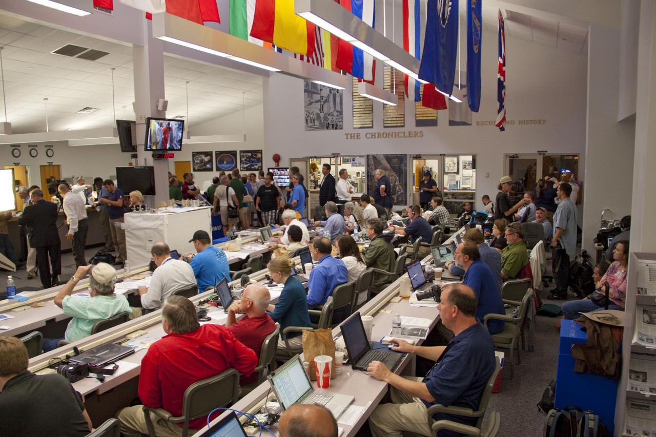CAPE CANAVERAL, Fla. -- Media from around the globe gather at the NASA News Center at NASA Kennedy Space Center's Press Site in Florida to cover the prelaunch activities and lift off of space shuttle Atlantis on its STS-135 mission to the International Space Station.             Atlantis began its final flight, with Commander Chris Ferguson, Pilot Doug Hurley and Mission Specialists Sandy Magnus and Rex Walheim on board, at 11:29 a.m. EDT July 8 to deliver the Raffaello multi-purpose logistics module packed with supplies and spare parts to the station. Also in Atlantis' payload bay is the Robotic Refueling Mission experiment that will investigate the potential for robotically refueling existing satellites in orbit. In addition, Atlantis will return with a failed ammonia pump module to help NASA better understand the failure mechanism and improve pump designs for future systems. STS-135 is the 33rd flight of Atlantis, the 37th shuttle mission to the space station, and the 135th and final mission of NASA's Space Shuttle Program. For more information, visit www.nasa.gov/mission_pages/shuttle/shuttlemissions/sts135/index.html. Photo credit: NASA/Jim Grossmann