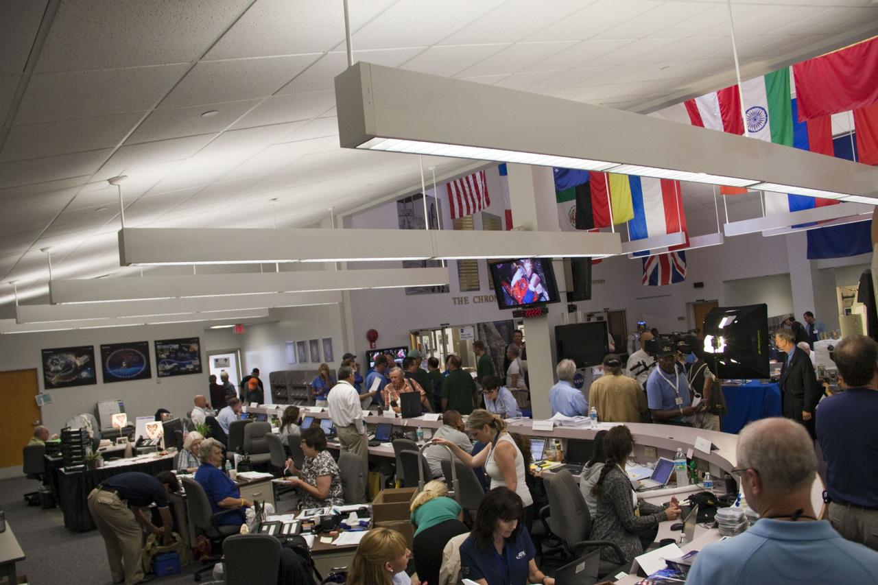 CAPE CANAVERAL, Fla. -- Media from around the globe gather at the NASA News Center at NASA Kennedy Space Center's Press Site in Florida to cover the prelaunch activities and lift off of space shuttle Atlantis on its STS-135 mission to the International Space Station. Volunteers can be seen at their desks answering questions and providing assistance.               Atlantis began its final flight, with Commander Chris Ferguson, Pilot Doug Hurley and Mission Specialists Sandy Magnus and Rex Walheim on board, at 11:29 a.m. EDT July 8 to deliver the Raffaello multi-purpose logistics module packed with supplies and spare parts to the station. Also in Atlantis' payload bay is the Robotic Refueling Mission experiment that will investigate the potential for robotically refueling existing satellites in orbit. In addition, Atlantis will return with a failed ammonia pump module to help NASA better understand the failure mechanism and improve pump designs for future systems. STS-135 is the 33rd flight of Atlantis, the 37th shuttle mission to the space station, and the 135th and final mission of NASA's Space Shuttle Program. For more information, visit www.nasa.gov/mission_pages/shuttle/shuttlemissions/sts135/index.html. Photo credit: NASA/Jim Grossmann