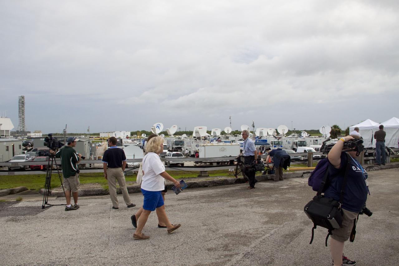 CAPE CANAVERAL, Fla. -- Media from around the globe gather on the grounds of the Press Site at NASA's Kennedy Space Center in Florida to photograph and cover the prelaunch activities and lift off of space shuttle Atlantis on its STS-135 mission to the International Space Station. Satellite news trucks, trailers and automobiles can be seen in the parking lot.                 Atlantis began its final flight, with Commander Chris Ferguson, Pilot Doug Hurley and Mission Specialists Sandy Magnus and Rex Walheim on board, at 11:29 a.m. EDT July 8 to deliver the Raffaello multi-purpose logistics module packed with supplies and spare parts to the station. Also in Atlantis' payload bay is the Robotic Refueling Mission experiment that will investigate the potential for robotically refueling existing satellites in orbit. In addition, Atlantis will return with a failed ammonia pump module to help NASA better understand the failure mechanism and improve pump designs for future systems. STS-135 is the 33rd flight of Atlantis, the 37th shuttle mission to the space station, and the 135th and final mission of NASA's Space Shuttle Program. For more information, visit www.nasa.gov/mission_pages/shuttle/shuttlemissions/sts135/index.html. Photo credit: NASA/Jim Grossmann
