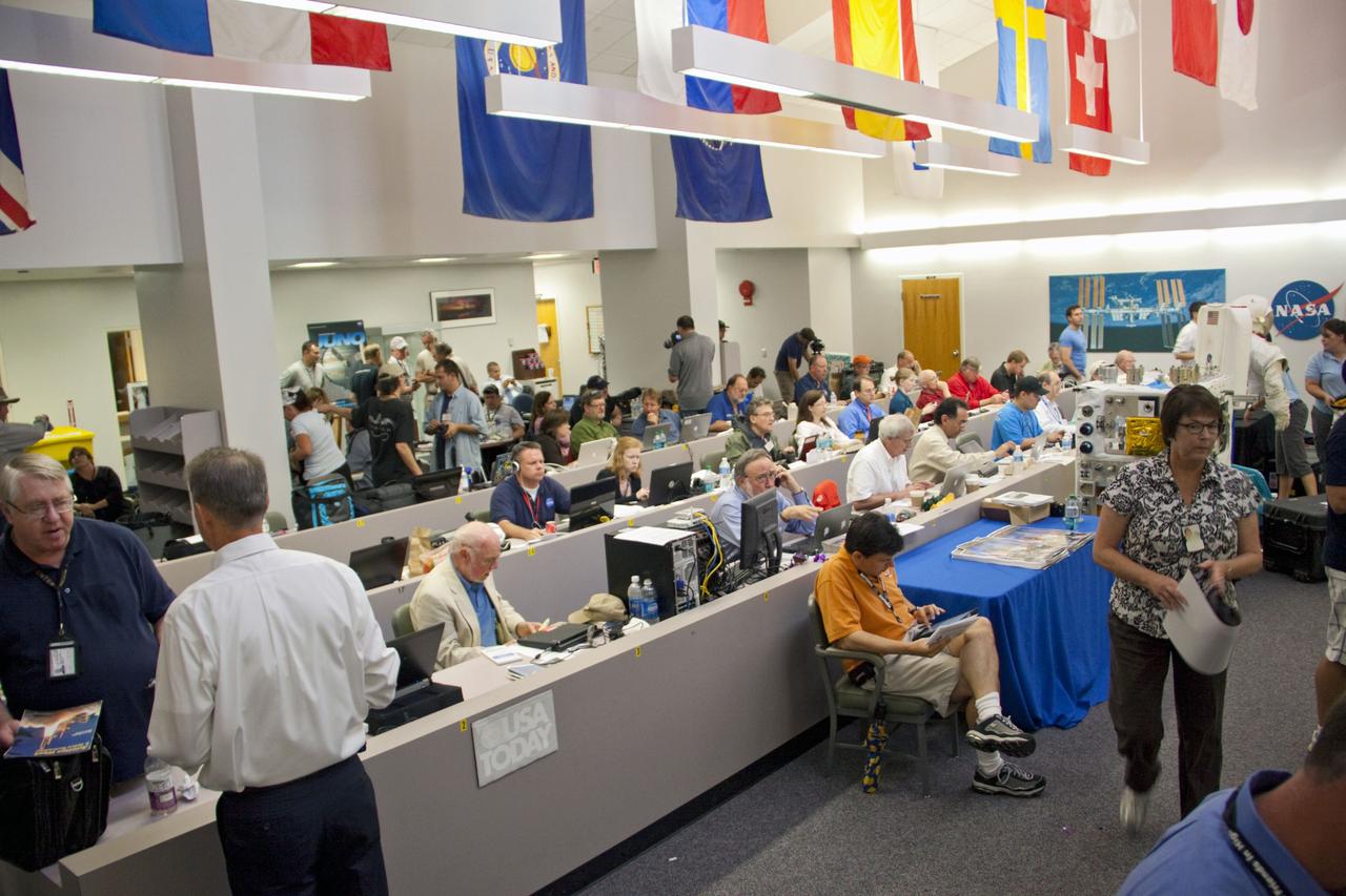 CAPE CANAVERAL, Fla. -- Media from around the globe gather at the NASA News Center at NASA Kennedy Space Center's Press Site in Florida to cover the prelaunch activities and lift off of space shuttle Atlantis on its STS-135 mission to the International Space Station.               Atlantis began its final flight, with Commander Chris Ferguson, Pilot Doug Hurley and Mission Specialists Sandy Magnus and Rex Walheim on board, at 11:29 a.m. EDT July 8 to deliver the Raffaello multi-purpose logistics module packed with supplies and spare parts to the station. Also in Atlantis' payload bay is the Robotic Refueling Mission experiment that will investigate the potential for robotically refueling existing satellites in orbit. In addition, Atlantis will return with a failed ammonia pump module to help NASA better understand the failure mechanism and improve pump designs for future systems. STS-135 is the 33rd flight of Atlantis, the 37th shuttle mission to the space station, and the 135th and final mission of NASA's Space Shuttle Program. For more information, visit www.nasa.gov/mission_pages/shuttle/shuttlemissions/sts135/index.html. Photo credit: NASA/Jim Grossmann