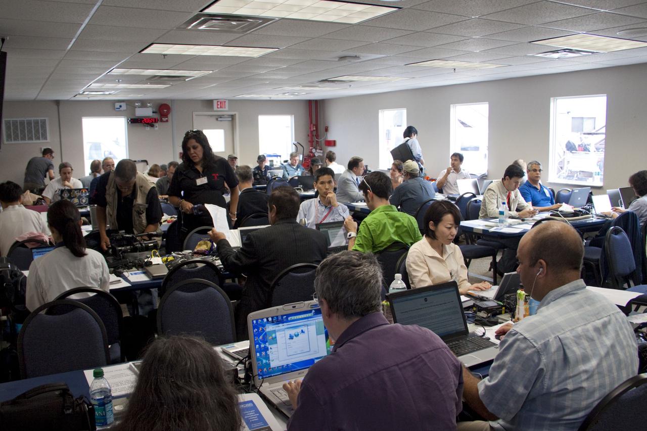 CAPE CANAVERAL, Fla. -- Media from around the globe gather at the NASA News Annex at NASA Kennedy Space Center's Press Site in Florida to cover the prelaunch activities and lift off of space shuttle Atlantis on its STS-135 mission to the International Space Station.              Atlantis began its final flight, with Commander Chris Ferguson, Pilot Doug Hurley and Mission Specialists Sandy Magnus and Rex Walheim on board, at 11:29 a.m. EDT July 8 to deliver the Raffaello multi-purpose logistics module packed with supplies and spare parts to the station. Also in Atlantis' payload bay is the Robotic Refueling Mission experiment that will investigate the potential for robotically refueling existing satellites in orbit. In addition, Atlantis will return with a failed ammonia pump module to help NASA better understand the failure mechanism and improve pump designs for future systems. STS-135 is the 33rd flight of Atlantis, the 37th shuttle mission to the space station, and the 135th and final mission of NASA's Space Shuttle Program. For more information, visit www.nasa.gov/mission_pages/shuttle/shuttlemissions/sts135/index.html. Photo credit: NASA/Jim Grossmann