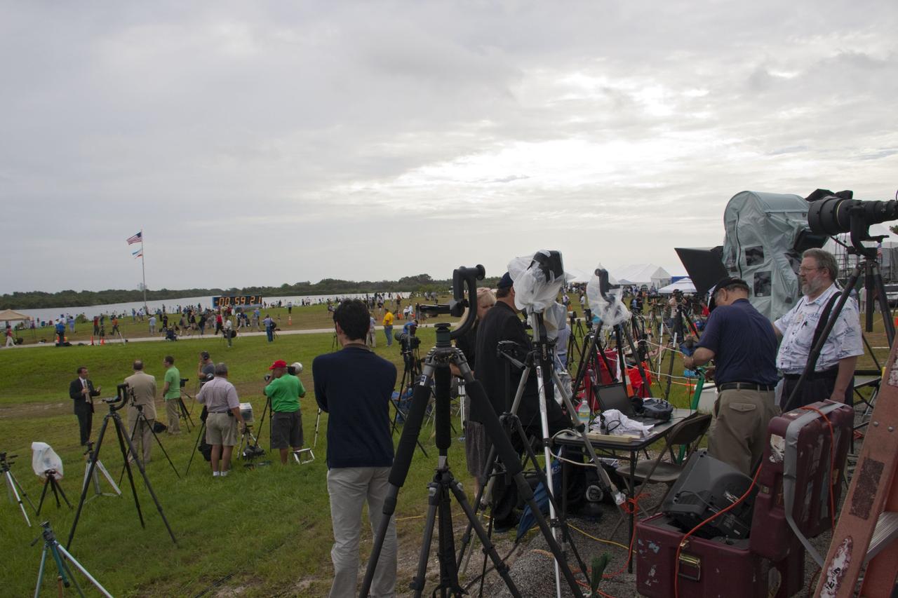 CAPE CANAVERAL, Fla. -- Media from around the globe gather on the grounds of the Press Site and countdown clock at NASA's Kennedy Space Center in Florida to photograph and cover the prelaunch activities and lift off of space shuttle Atlantis on its STS-135 mission to the International Space Station.                  Atlantis began its final flight, with Commander Chris Ferguson, Pilot Doug Hurley and Mission Specialists Sandy Magnus and Rex Walheim on board, at 11:29 a.m. EDT July 8 to deliver the Raffaello multi-purpose logistics module packed with supplies and spare parts to the station. Also in Atlantis' payload bay is the Robotic Refueling Mission experiment that will investigate the potential for robotically refueling existing satellites in orbit. In addition, Atlantis will return with a failed ammonia pump module to help NASA better understand the failure mechanism and improve pump designs for future systems. STS-135 is the 33rd flight of Atlantis, the 37th shuttle mission to the space station, and the 135th and final mission of NASA's Space Shuttle Program. For more information, visit www.nasa.gov/mission_pages/shuttle/shuttlemissions/sts135/index.html. Photo credit: NASA/Jim Grossmann