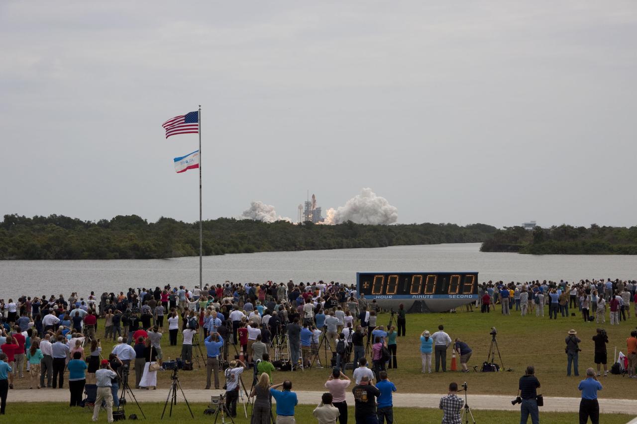 CAPE CANAVERAL, Fla. -- Members of the media and employees gather near the countdown clock to see this rocket's red glare for the last time as space shuttle Atlantis roars off Launch Pad 39A at NASA's Kennedy Space Center in Florida at 11:29 a.m. EDT on July 8. On board are four experienced astronauts -- STS-135 Commander Chris Ferguson, Pilot Doug Hurley, and Mission Specialists Sandy Magnus and Rex Walheim.      STS-135 will deliver the Raffaello multi-purpose logistics module packed with supplies and spare parts for the International Space Station. Atlantis also will fly the Robotic Refueling Mission experiment that will investigate the potential for robotically refueling existing satellites in orbit. In addition, Atlantis will return with a failed ammonia pump module to help NASA better understand the failure mechanism and improve pump designs for future systems. STS-135 will be the 33rd flight of Atlantis, the 37th shuttle mission to the space station, and the 135th and final mission of NASA's Space Shuttle Program. For more information, visit www.nasa.gov/mission_pages/shuttle/shuttlemissions/sts135/index.html. Photo credit: NASA/Jim Grossmann
