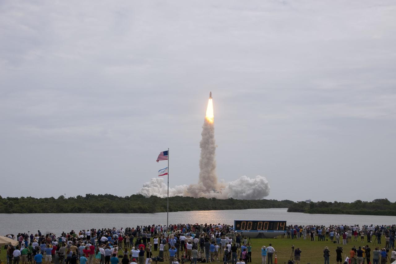 CAPE CANAVERAL, Fla. -- Members of the media and employees gather near the countdown clock to see this rocket's red glare for the last time as space shuttle Atlantis roars off Launch Pad 39A at NASA's Kennedy Space Center in Florida at 11:29 a.m. EDT on July 8. On board are four experienced astronauts -- STS-135 Commander Chris Ferguson, Pilot Doug Hurley, and Mission Specialists Sandy Magnus and Rex Walheim.       STS-135 will deliver the Raffaello multi-purpose logistics module packed with supplies and spare parts for the International Space Station. Atlantis also will fly the Robotic Refueling Mission experiment that will investigate the potential for robotically refueling existing satellites in orbit. In addition, Atlantis will return with a failed ammonia pump module to help NASA better understand the failure mechanism and improve pump designs for future systems. STS-135 will be the 33rd flight of Atlantis, the 37th shuttle mission to the space station, and the 135th and final mission of NASA's Space Shuttle Program. For more information, visit www.nasa.gov/mission_pages/shuttle/shuttlemissions/sts135/index.html. Photo credit: NASA/Jim Grossmann