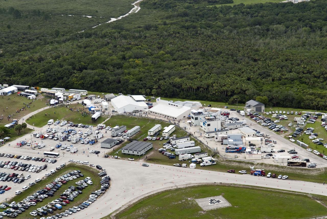 CAPE CANAVERAL, Fla. -- Taken from the Vehicle Assembly Building roof at NASA's Kennedy Space Center in Florida, this image shows the Press Site complex with a myriad of vehicles, satellite trucks and trailers belonging to invited guests and media for the launch of space shuttle Atlantis. Atlantis began its final flight, the STS-135 mission to the International Space Station, at 11:29 a.m. EDT on July 8.        STS-135 will deliver the Raffaello multi-purpose logistics module packed with supplies and spare parts for the International Space Station. Atlantis also will fly the Robotic Refueling Mission experiment that will investigate the potential for robotically refueling existing satellites in orbit. In addition, Atlantis will return with a failed ammonia pump module to help NASA better understand the failure mechanism and improve pump designs for future systems. STS-135 will be the 33rd flight of Atlantis, the 37th shuttle mission to the space station, and the 135th and final mission of NASA's Space Shuttle Program. For more information, visit www.nasa.gov/mission_pages/shuttle/shuttlemissions/sts135/index.html. Photo credit: NASA/Jeffrey Marino