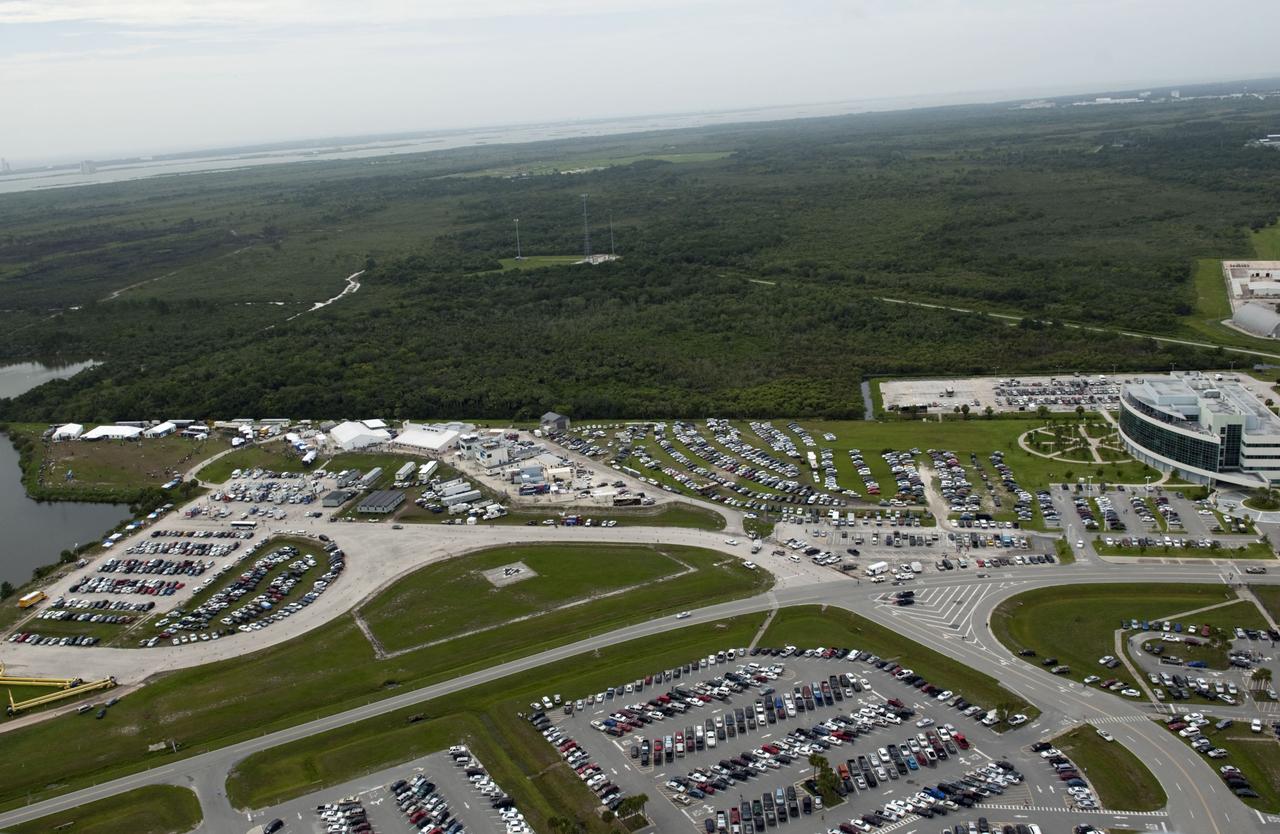 CAPE CANAVERAL, Fla. -- Taken from the Vehicle Assembly Building roof at NASA's Kennedy Space Center in Florida, this image shows the Press Site complex with a myriad of vehicles, satellite trucks and trailers belonging to invited guests and media for the launch of space shuttle Atlantis. Atlantis began its final flight, the STS-135 mission, to the International Space Station at 11:29 a.m. EDT on July 8.        STS-135 will deliver the Raffaello multi-purpose logistics module packed with supplies and spare parts for the International Space Station. Atlantis also will fly the Robotic Refueling Mission experiment that will investigate the potential for robotically refueling existing satellites in orbit. In addition, Atlantis will return with a failed ammonia pump module to help NASA better understand the failure mechanism and improve pump designs for future systems. STS-135 will be the 33rd flight of Atlantis, the 37th shuttle mission to the space station, and the 135th and final mission of NASA's Space Shuttle Program. For more information, visit www.nasa.gov/mission_pages/shuttle/shuttlemissions/sts135/index.html. Photo credit: NASA/Jeffrey Marino