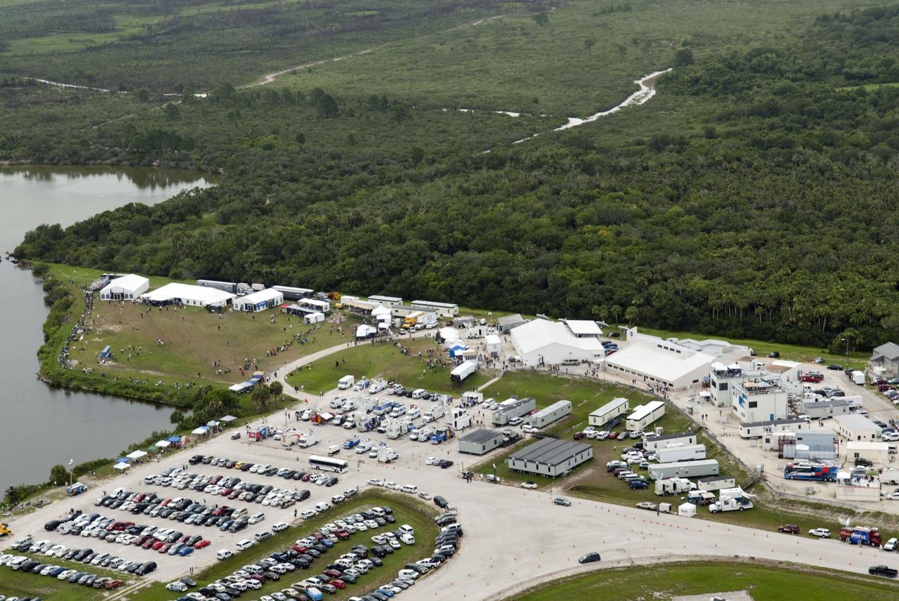 CAPE CANAVERAL, Fla. -- Taken from the Vehicle Assembly Building roof at NASA's Kennedy Space Center in Florida, this image shows the Press Site complex with a myriad of vehicles, satellite trucks and trailers belonging to invited guests and media for the launch of space shuttle Atlantis. Atlantis began its final flight, the STS-135 mission to the International Space Station, at 11:29 a.m. EDT on July 8.       STS-135 will deliver the Raffaello multi-purpose logistics module packed with supplies and spare parts for the International Space Station. Atlantis also will fly the Robotic Refueling Mission experiment that will investigate the potential for robotically refueling existing satellites in orbit. In addition, Atlantis will return with a failed ammonia pump module to help NASA better understand the failure mechanism and improve pump designs for future systems. STS-135 will be the 33rd flight of Atlantis, the 37th shuttle mission to the space station, and the 135th and final mission of NASA's Space Shuttle Program. For more information, visit www.nasa.gov/mission_pages/shuttle/shuttlemissions/sts135/index.html. Photo credit: NASA/Jeffrey Marino