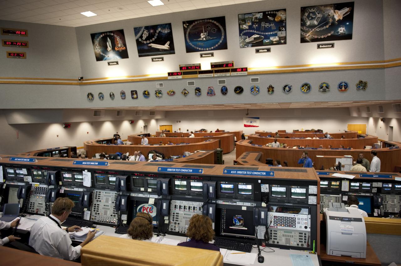 CAPE CANAVERAL, Fla. -- In Firing Room 4 of the Launch Control Center at NASA's Kennedy Space Center in Florida, launch team members monitor the countdown to the launch of space shuttle Atlantis on its STS-135 mission to the International Space Station. Above the space shuttle countdown clock are five orbiter tributes on display. The tributes feature major accomplishments and significant achievements made by each shuttle, as well as mission patches and processing milestones.              Atlantis with its crew of four; Commander Chris Ferguson, Pilot Doug Hurley, Mission Specialists Sandy Magnus and Rex Walheim, lifted off at 11:29 a.m. EDT on July 8, 2011 to deliver the Raffaello multi-purpose logistics module packed with supplies and spare parts for the station. Atlantis also will fly the Robotic Refueling Mission experiment that will investigate the potential for robotically refueling existing satellites in orbit. In addition, Atlantis will return with a failed ammonia pump module to help NASA better understand the failure mechanism and improve pump designs for future systems. STS-135 will be the 33rd flight of Atlantis, the 37th shuttle mission to the space station, and the 135th and final mission of NASA's Space Shuttle Program. For more information, visit www.nasa.gov/mission_pages/shuttle/shuttlemissions/sts135/index.html. Photo credit: NASA/Kim Shiflett