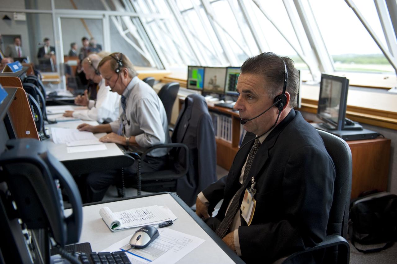 CAPE CANAVERAL, Fla. -- In Firing Room 4 of the Launch Control Center at NASA's Kennedy Space Center in Florida, launch team members monitor the countdown to the launch of space shuttle Atlantis on its STS-135 mission to the International Space Station. Seen here are Assistant Launch Director Pete Nickolenko (background) Shuttle Launch Director Mike Leinbach and Payloads Launch Manager and Deputy Director of ISS and Spacecraft Processing at Kennedy, Bill Dowdell.                  Atlantis with its crew of four; Commander Chris Ferguson, Pilot Doug Hurley, Mission Specialists Sandy Magnus and Rex Walheim, lifted off at 11:29 a.m. EDT on July 8, 2011 to deliver the Raffaello multi-purpose logistics module packed with supplies and spare parts for the station. Atlantis also will fly the Robotic Refueling Mission experiment that will investigate the potential for robotically refueling existing satellites in orbit. In addition, Atlantis will return with a failed ammonia pump module to help NASA better understand the failure mechanism and improve pump designs for future systems. STS-135 will be the 33rd flight of Atlantis, the 37th shuttle mission to the space station, and the 135th and final mission of NASA's Space Shuttle Program. For more information, visit www.nasa.gov/mission_pages/shuttle/shuttlemissions/sts135/index.html. Photo credit: NASA/Kim Shiflett