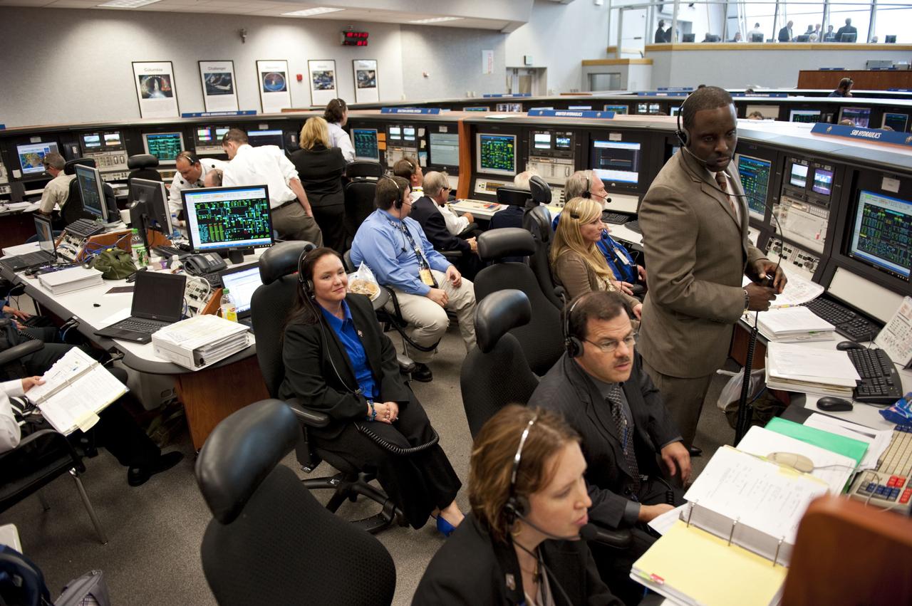 CAPE CANAVERAL, Fla. -- In Firing Room 4 of the Launch Control Center at NASA's Kennedy Space Center in Florida, launch team members monitor the countdown to the launch of space shuttle Atlantis on its STS-135 mission to the International Space Station.              Atlantis with its crew of four; Commander Chris Ferguson, Pilot Doug Hurley, Mission Specialists Sandy Magnus and Rex Walheim, lifted off at 11:29 a.m. EDT on July 8, 2011 to deliver the Raffaello multi-purpose logistics module packed with supplies and spare parts for the station. Atlantis also will fly the Robotic Refueling Mission experiment that will investigate the potential for robotically refueling existing satellites in orbit. In addition, Atlantis will return with a failed ammonia pump module to help NASA better understand the failure mechanism and improve pump designs for future systems. STS-135 will be the 33rd flight of Atlantis, the 37th shuttle mission to the space station, and the 135th and final mission of NASA's Space Shuttle Program. For more information, visit www.nasa.gov/mission_pages/shuttle/shuttlemissions/sts135/index.html. Photo credit: NASA/Kim Shiflett