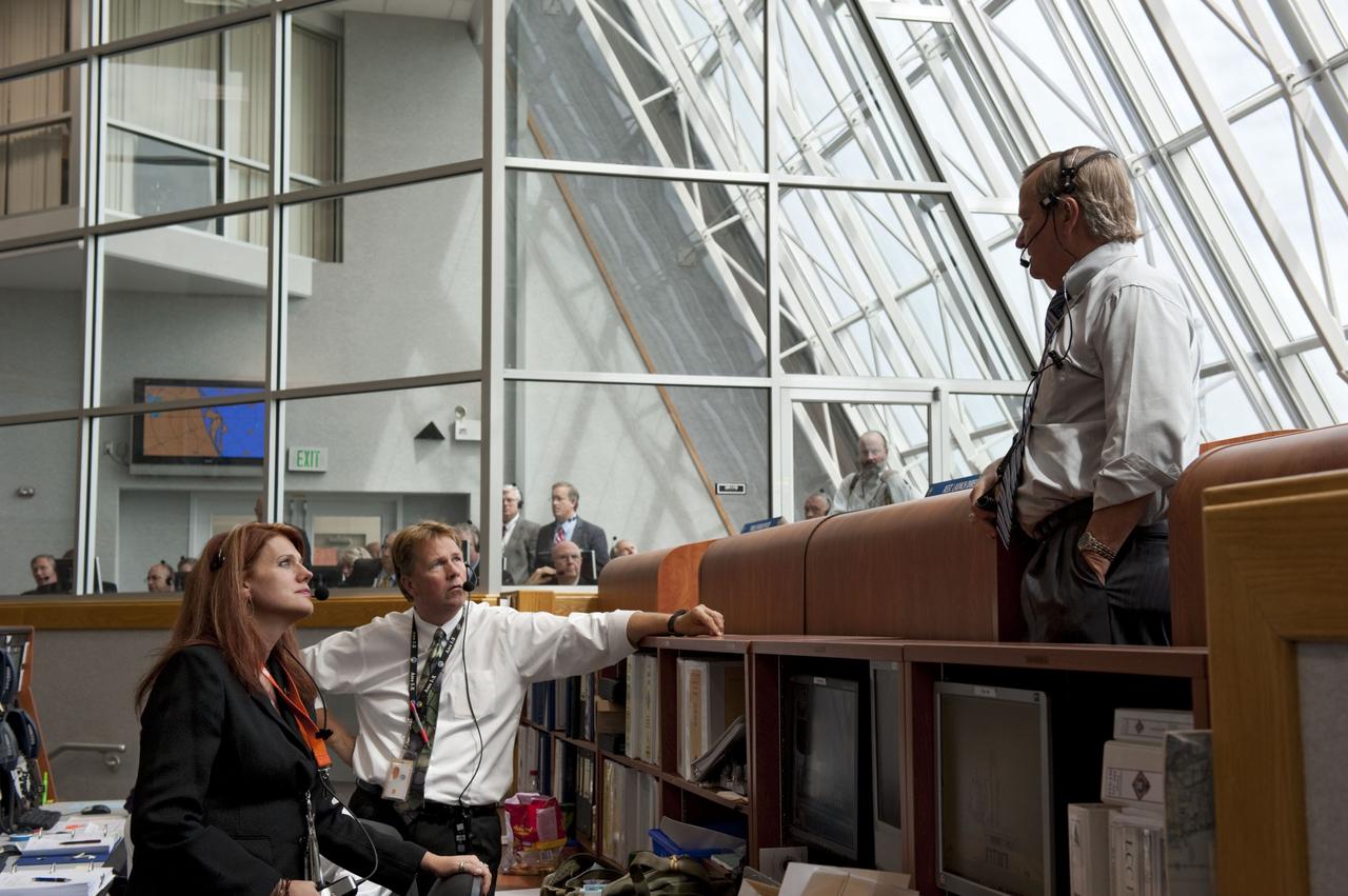 CAPE CANAVERAL, Fla. -- In Firing Room 4 of the Launch Control Center at NASA's Kennedy Space Center in Florida, Shuttle Launch Director Mike Leinbach speaks with NASA Test Directors Jeff Spaulding (center) and Charlie Blackwell-Thompson during the countdown to the launch of space shuttle Atlantis on its STS-135 mission to the International Space Station. Atlantis with its crew of four; Commander Chris Ferguson, Pilot Doug Hurley, Mission Specialists Sandy Magnus and Rex Walheim, lifted off at 11:29 a.m. EDT on July 8, 2011 to deliver the Raffaello multi-purpose logistics module packed with supplies and spare parts for the station. Atlantis also will fly the Robotic Refueling Mission experiment that will investigate the potential for robotically refueling existing satellites in orbit. In addition, Atlantis will return with a failed ammonia pump module to help NASA better understand the failure mechanism and improve pump designs for future systems. STS-135 will be the 33rd flight of Atlantis, the 37th shuttle mission to the space station, and the 135th and final mission of NASA's Space Shuttle Program. For more information, visit www.nasa.gov/mission_pages/shuttle/shuttlemissions/sts135/index.html. Photo credit: NASA/Kim Shiflett