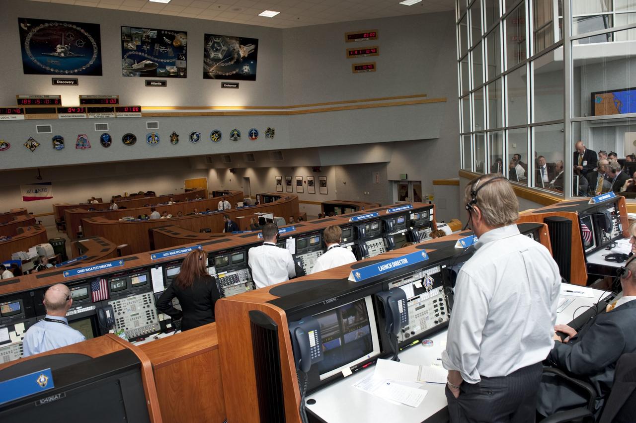 CAPE CANAVERAL, Fla. -- In Firing Room 4 of the Launch Control Center at NASA's Kennedy Space Center in Florida, Shuttle Launch Director Mike Leinbach oversees the countdown to the launch of space shuttle Atlantis on its STS-135 mission to the International Space Station. Atlantis with its crew of four; Commander Chris Ferguson, Pilot Doug Hurley, Mission Specialists Sandy Magnus and Rex Walheim, lifted off at 11:29 a.m. EDT on July 8, 2011 to deliver the Raffaello multi-purpose logistics module packed with supplies and spare parts for the station. Atlantis also will fly the Robotic Refueling Mission experiment that will investigate the potential for robotically refueling existing satellites in orbit. In addition, Atlantis will return with a failed ammonia pump module to help NASA better understand the failure mechanism and improve pump designs for future systems. STS-135 will be the 33rd flight of Atlantis, the 37th shuttle mission to the space station, and the 135th and final mission of NASA's Space Shuttle Program. For more information, visit www.nasa.gov/mission_pages/shuttle/shuttlemissions/sts135/index.html. Photo credit: NASA/Kim Shiflett