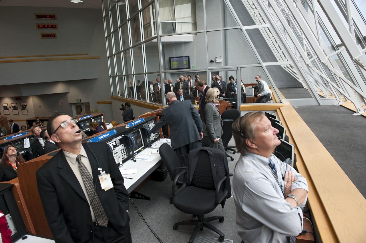 CAPE CANAVERAL, Fla. -- In Firing Room 4 of the Launch Control Center at NASA's Kennedy Space Center in Florida, Shuttle Launch Director Mike Leinbach, and Payloads Launch Manager and Deputy Director of ISS and Spacecraft Processing at Kennedy, Bill Dowdell along with the launch control members, watch intently as space shuttle Atlantis lifts off on its STS-135 mission to the International Space Station. Atlantis with its crew of four; Commander Chris Ferguson, Pilot Doug Hurley, Mission Specialists Sandy Magnus and Rex Walheim, lifted off at 11:29 a.m. EDT on July 8, 2011 to deliver the Raffaello multi-purpose logistics module packed with supplies and spare parts for the station. Atlantis also will fly the Robotic Refueling Mission experiment that will investigate the potential for robotically refueling existing satellites in orbit. In addition, Atlantis will return with a failed ammonia pump module to help NASA better understand the failure mechanism and improve pump designs for future systems. STS-135 will be the 33rd flight of Atlantis, the 37th shuttle mission to the space station, and the 135th and final mission of NASA's Space Shuttle Program. For more information, visit www.nasa.gov/mission_pages/shuttle/shuttlemissions/sts135/index.html. Photo credit: NASA/Kim Shiflett