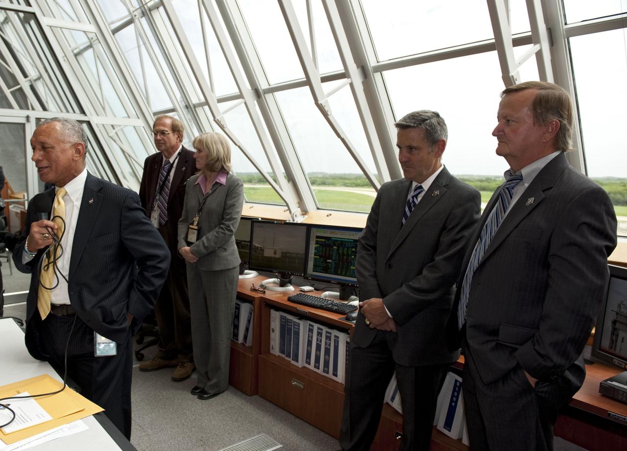 CAPE CANAVERAL, Fla. -- NASA Administrator Charlie Bolden congratulates the launch team in Firing Room 4 of the Launch Control Center following the successful launch of space shuttle Atlantis from NASA's Kennedy Space Center in Florida. Behind Bolden, from left, are STS-135 Launch Commentator George Diller, Atlantis' NASA Flow Director Angie Brewer, Kennedy Space Center Director Bob Cabana and Shuttle Launch Director Mike Leinbach. Atlantis began its final flight, the STS-135 mission to the International Space Station, at 11:29 a.m. EDT on July 8. STS-135 will deliver the Raffaello multi-purpose logistics module packed with supplies and spare parts for the International Space Station. Atlantis also is flying the Robotic Refueling Mission experiment that will investigate the potential for robotically refueling existing satellites in orbit. In addition, Atlantis will return with a failed ammonia pump module to help NASA better understand the failure mechanism and improve pump designs for future systems. STS-135 is the 33rd flight of Atlantis, the 37th shuttle mission to the space station, and the 135th and final mission of NASA's Space Shuttle Program. For more information, visit www.nasa.gov/mission_pages/shuttle/shuttlemissions/sts135/index.html. Photo credit: NASA/Kim Shiflett