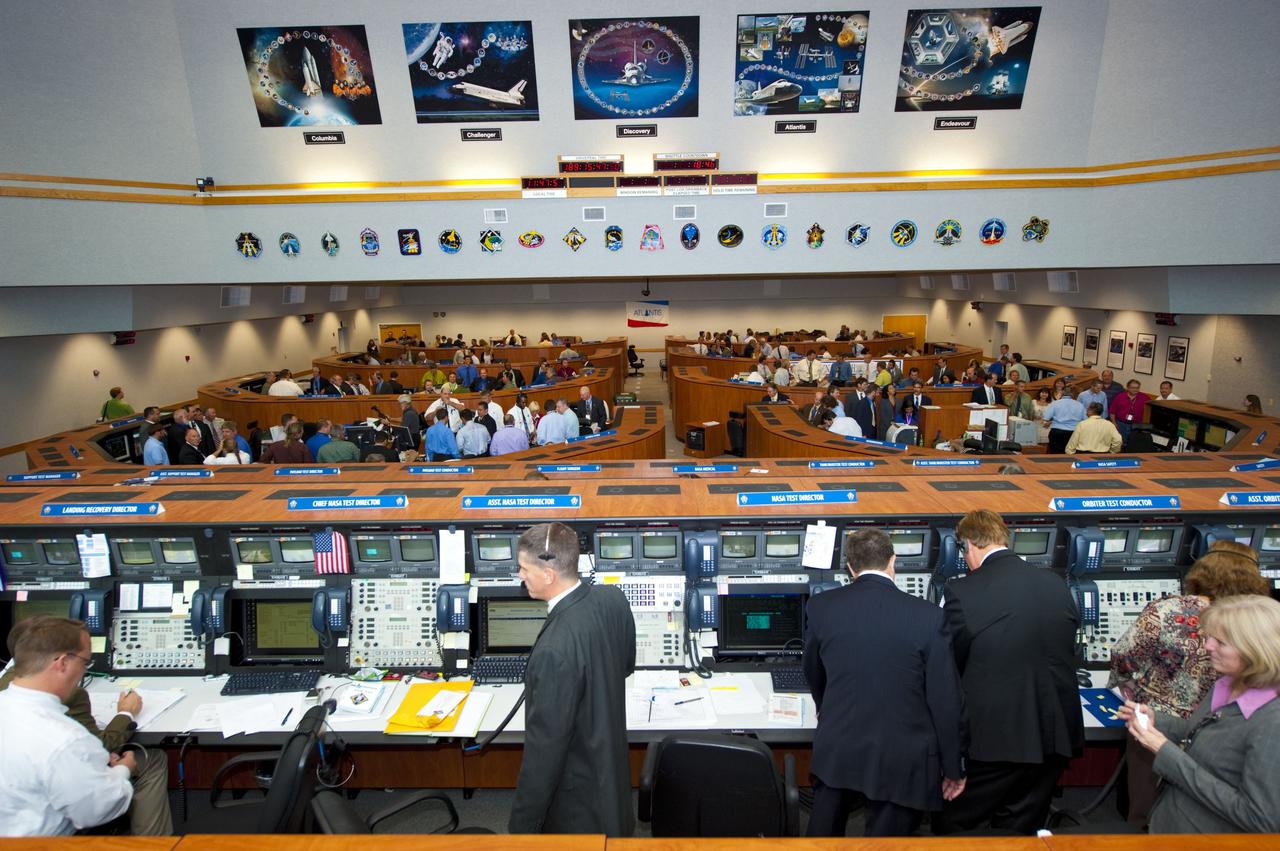 CAPE CANAVERAL, Fla. -- In Firing Room 4 of the Launch Control Center, the launch team reflects on the successful launch of space shuttle Atlantis from NASA's Kennedy Space Center in Florida. Atlantis began its final flight, the STS-135 mission to the International Space Station, at 11:29 a.m. EDT on July 8. STS-135 will deliver the Raffaello multi-purpose logistics module packed with supplies and spare parts for the International Space Station. Atlantis also is flying the Robotic Refueling Mission experiment that will investigate the potential for robotically refueling existing satellites in orbit. In addition, Atlantis will return with a failed ammonia pump module to help NASA better understand the failure mechanism and improve pump designs for future systems. STS-135 is the 33rd flight of Atlantis, the 37th shuttle mission to the space station, and the 135th and final mission of NASA's Space Shuttle Program. For more information, visit www.nasa.gov/mission_pages/shuttle/shuttlemissions/sts135/index.html. Photo credit: NASA/Kim Shiflett