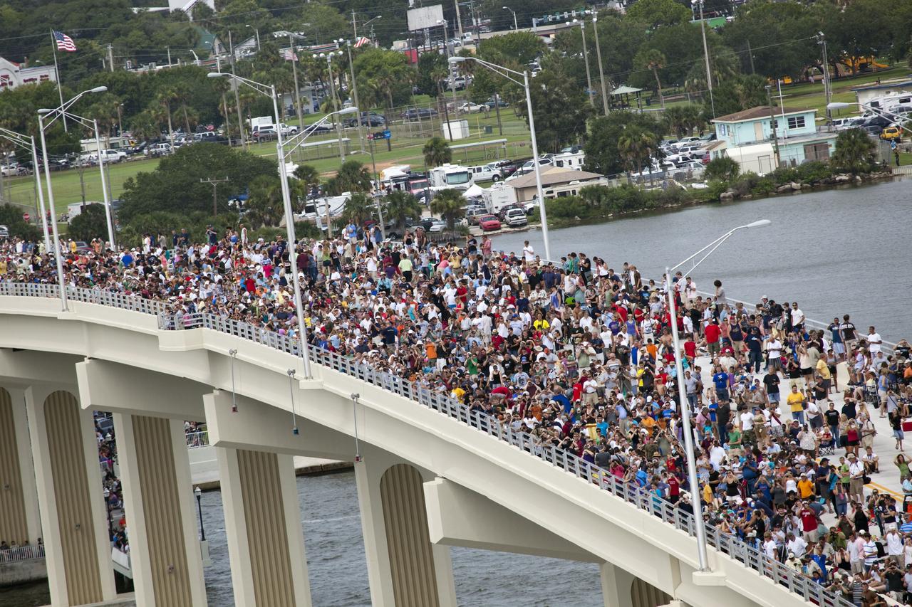 CAPE CANAVERAL, Fla. -- After 30 years and 135 missions, residents and visitors to Florida's Space Coast crowd the new A. Max Brewer Bridge in Titusville to see the rocket's red glare of NASA's Space Shuttle Program soar for the last time. Space shuttle Atlantis is scheduled to liftoff at 11:26 a.m. EDT from Launch Pad 39A at NASA's Kennedy Space Center in Florida. On board will be four experienced astronauts -- STS-135 Commander Chris Ferguson, Pilot Doug Hurley, and Mission Specialists Sandy Magnus and Rex Walheim.        STS-135 will deliver the Raffaello multi-purpose logistics module packed with supplies and spare parts for the International Space Station. Atlantis also will fly the Robotic Refueling Mission experiment that will investigate the potential for robotically refueling existing satellites in orbit. In addition, Atlantis will return with a failed ammonia pump module to help NASA better understand the failure mechanism and improve pump designs for future systems. STS-135 will be the 33rd flight of Atlantis, the 37th shuttle mission to the space station, and the 135th and final mission of NASA's Space Shuttle Program. For more information visit, www.nasa.gov/mission_pages/shuttle/shuttlemissions/sts135/index.html. Photo credit: NASA/Frank Michaux