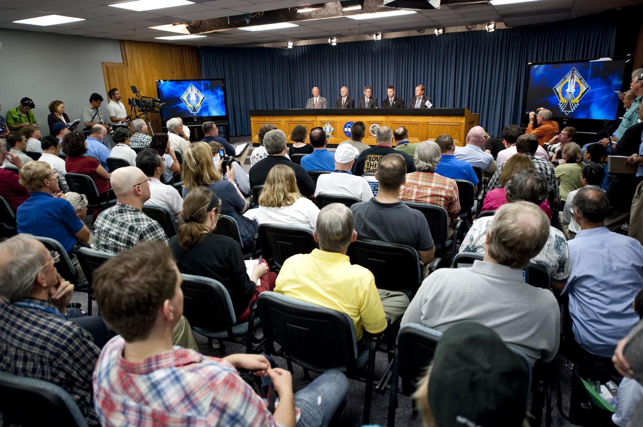 CAPE CANAVERAL, Fla. -- Members of the media gather for a post-launch news conference held in the Press Site auditorium at NASA's Kennedy Space Center in Florida, following the successful launch of space shuttle Atlantis on its STS-135 mission to the International Space Station. Seen here are NASA Public Affairs Officer Mike Curie (left) moderator; Associate Administrator for Space Operations Bill Gerstenmaier, Kennedy Center Director Bob Cabana, Shuttle Program Launch Integration Manager Mike Moses, and Shuttle Launch Director Mike Leinbach. Atlantis began its final flight at 11:29 a.m. EDT on July 8. STS-135 will deliver the Raffaello multi-purpose logistics module packed with supplies and spare parts for the International Space Station. Atlantis also will fly the Robotic Refueling Mission experiment that will investigate the potential for robotically refueling existing satellites in orbit. In addition, Atlantis will return with a failed ammonia pump module to help NASA better understand the failure mechanism and improve pump designs for future systems. STS-135 will be the 33rd flight of Atlantis, the 37th shuttle mission to the space station, and the 135th and final mission of NASA's Space Shuttle Program. For more information, visit www.nasa.gov/mission_pages/shuttle/shuttlemissions/sts135/index.html. Photo credit: NASA/Kim Shiflett