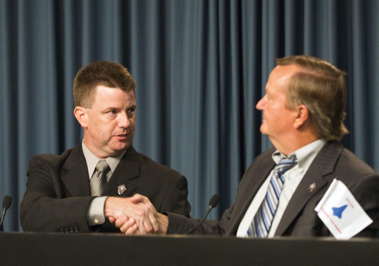 CAPE CANAVERAL, Fla. -- After a briefing in the Press Site auditorium at NASA's Kennedy Space Center in Florida, Shuttle Program Launch Integration Manager Mike Moses congratulates Shuttle Launch Director Mike Leinbach after the successful launch of space shuttle Atlantis. Atlantis began its final flight at 11:29 a.m. EDT on July 8. STS-135 will deliver the Raffaello multi-purpose logistics module packed with supplies and spare parts for the International Space Station. Atlantis also will fly the Robotic Refueling Mission experiment that will investigate the potential for robotically refueling existing satellites in orbit. In addition, Atlantis will return with a failed ammonia pump module to help NASA better understand the failure mechanism and improve pump designs for future systems. STS-135 will be the 33rd flight of Atlantis, the 37th shuttle mission to the space station, and the 135th and final mission of NASA's Space Shuttle Program. For more information, visit www.nasa.gov/mission_pages/shuttle/shuttlemissions/sts135/index.html. Photo credit: NASA/Kim Shiflett
